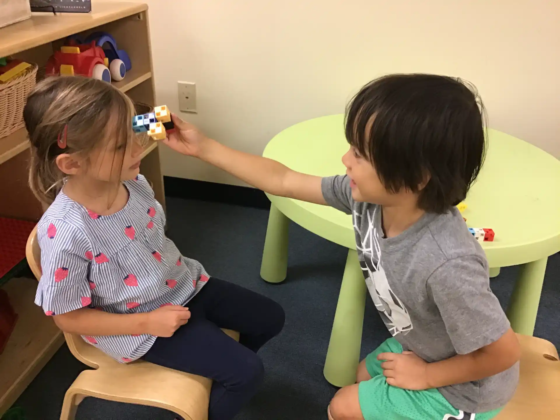 a couple of children playing with toys