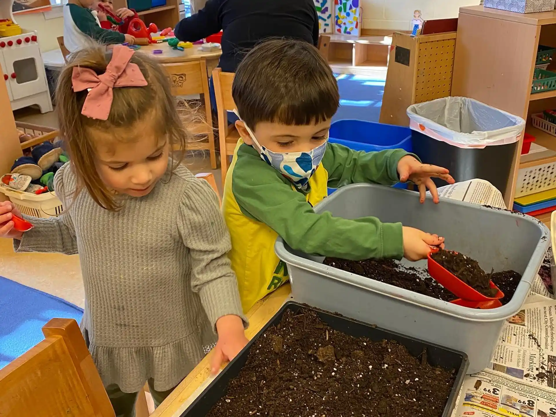 children playing with water in a bucket