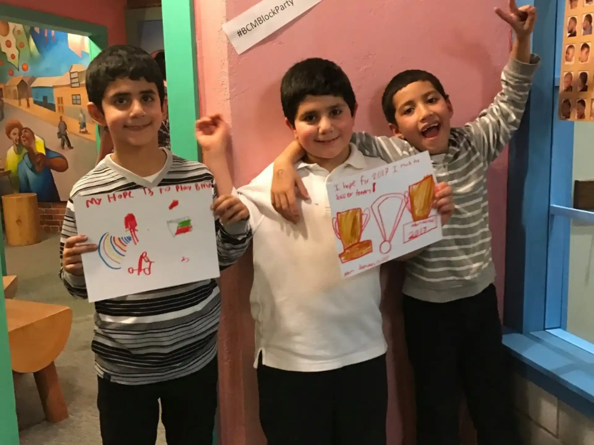 a group of boys holding up a sign