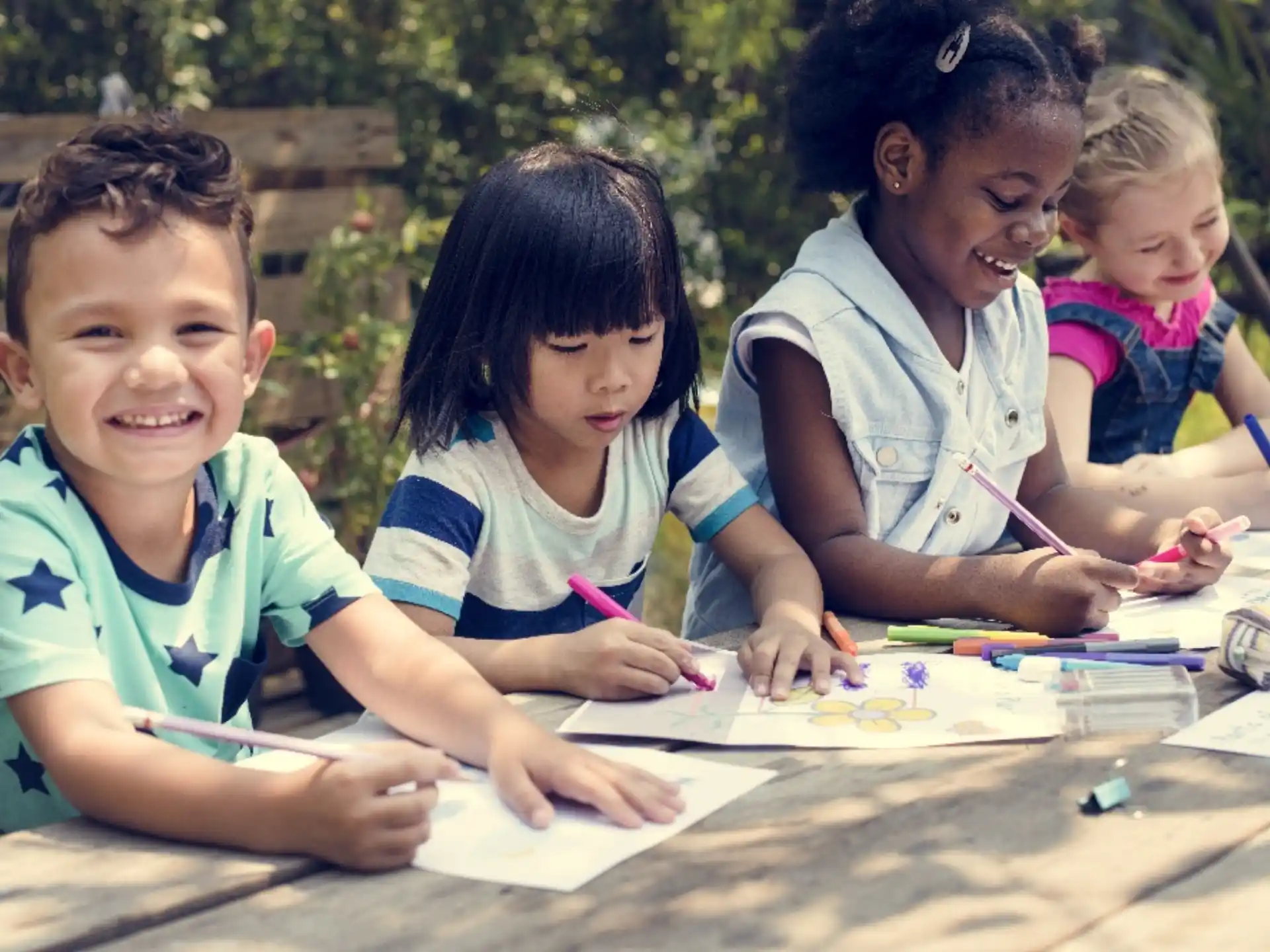 a group of children sitting at a table