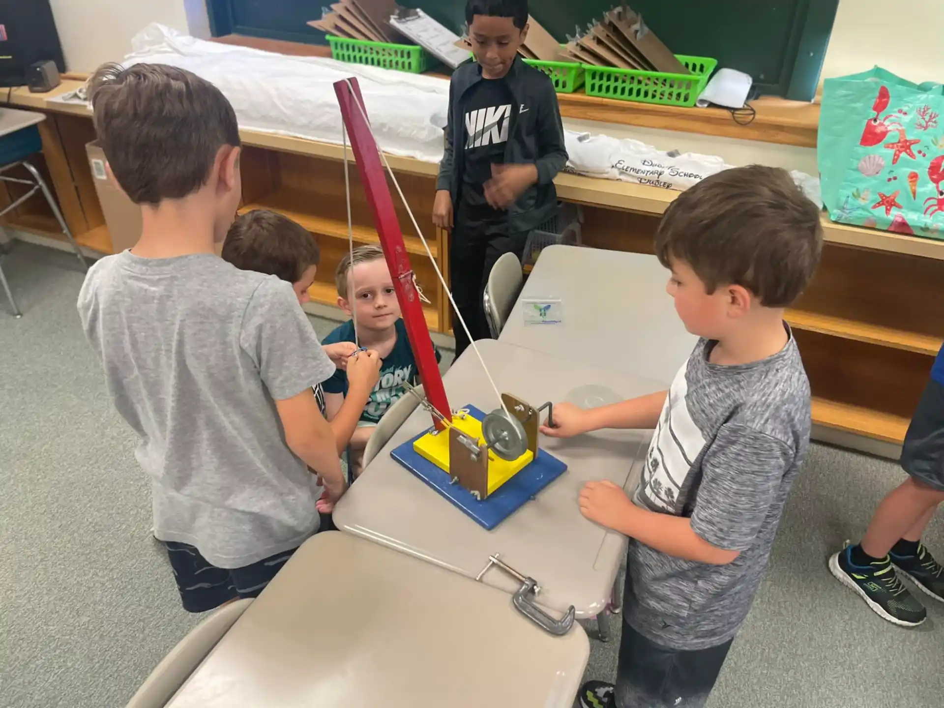 a group of kids playing with a toy train