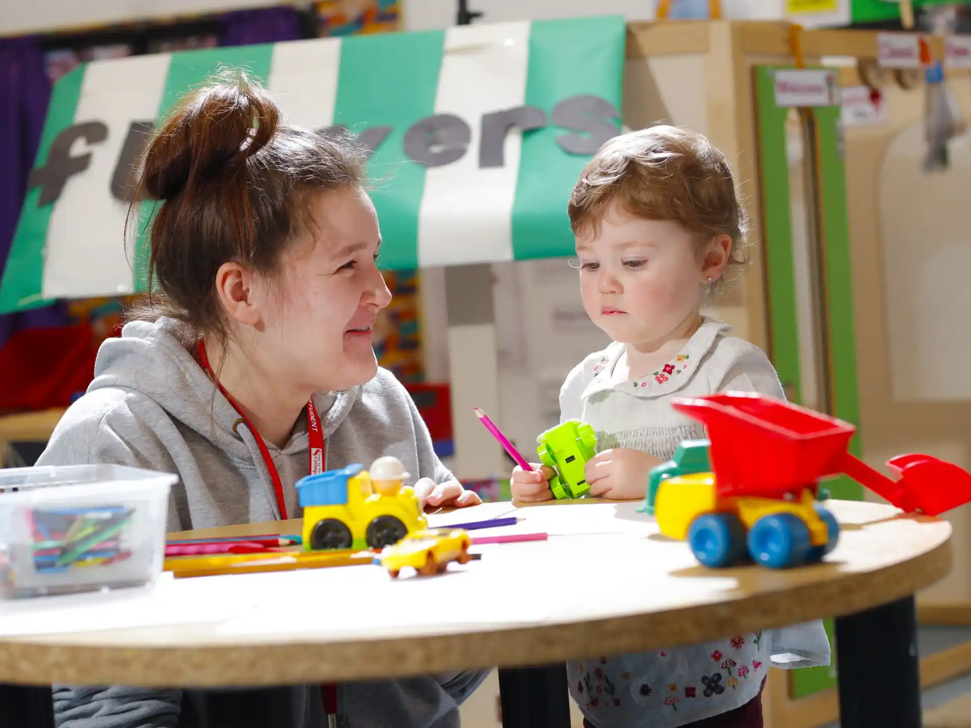a person and a child playing with toys