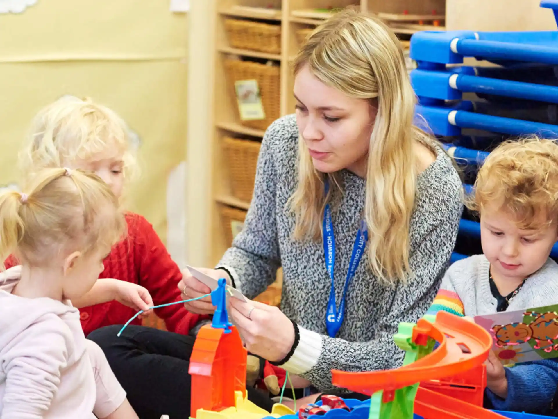 a person and children playing with toys