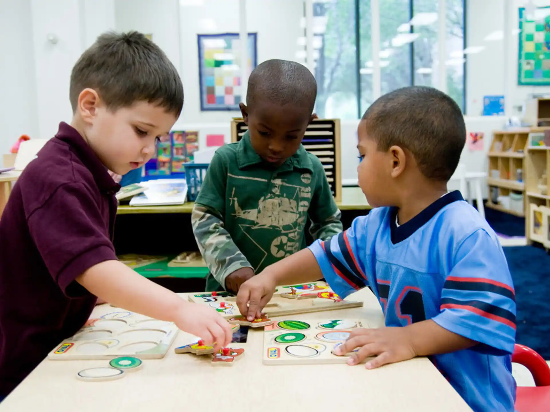 a few boys playing with a puzzle