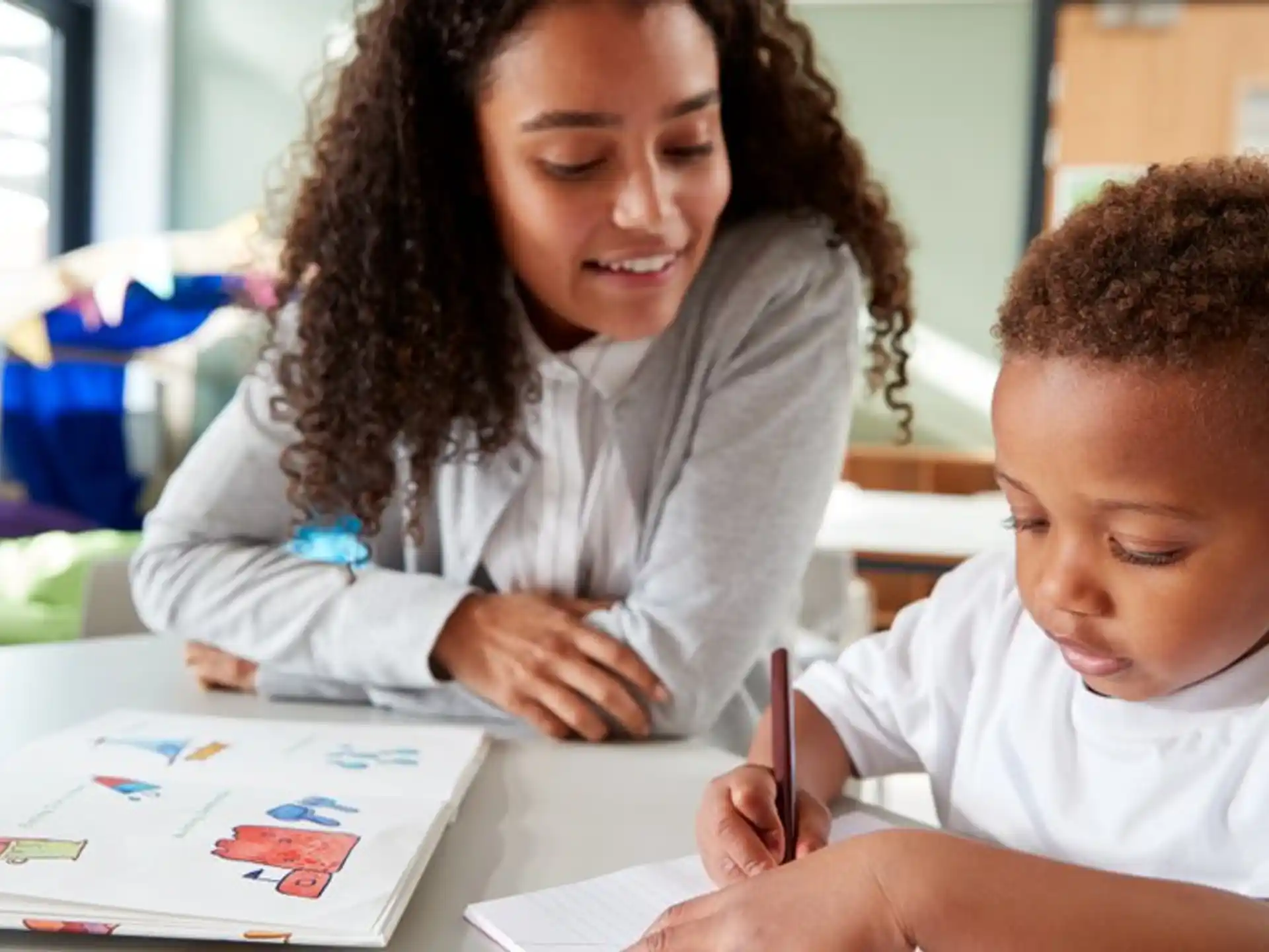 a person and a child writing on a book