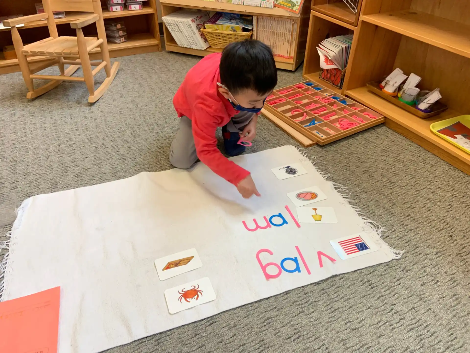 a boy drawing on a white board