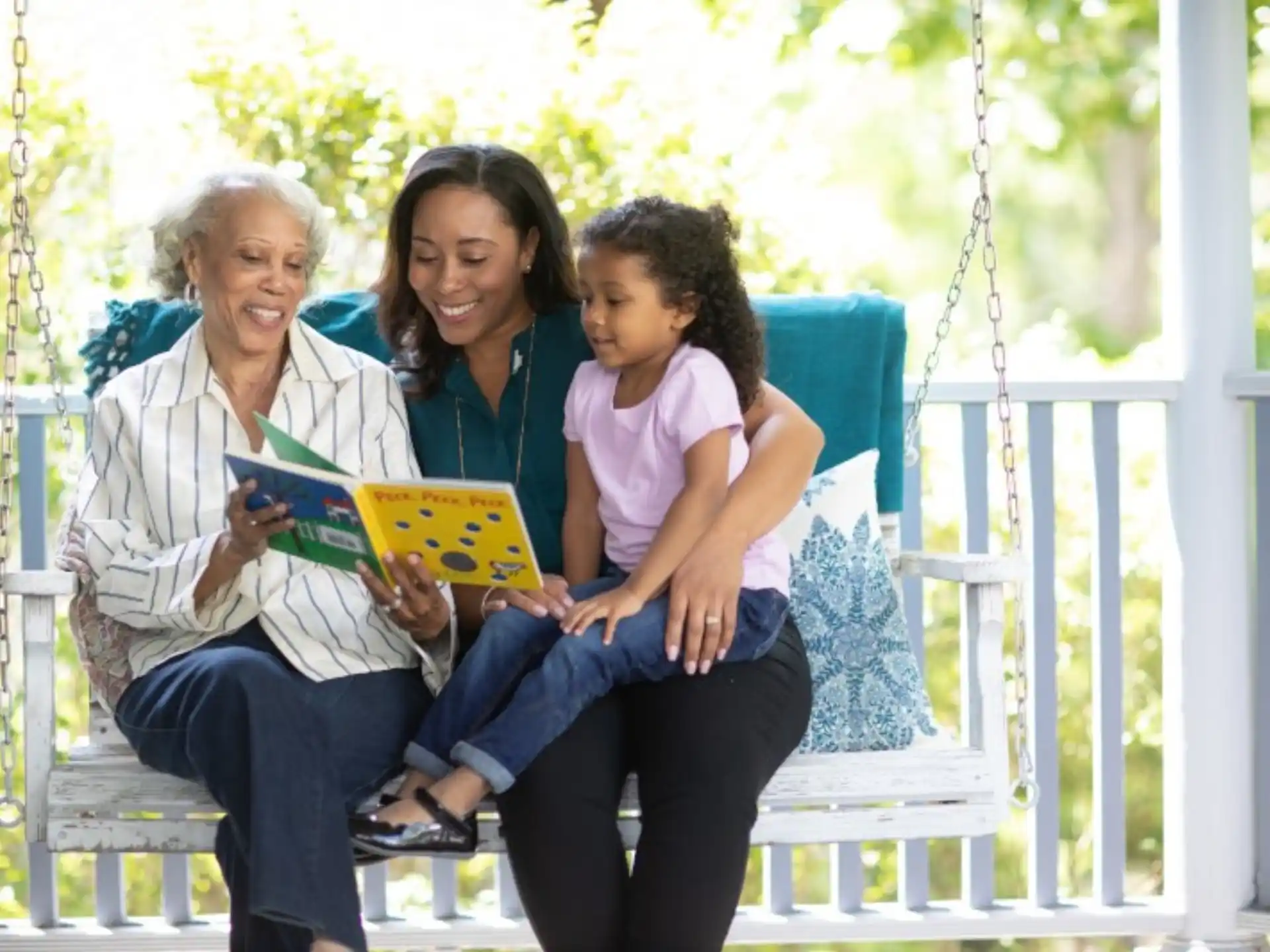 a group of women sitting on a swing