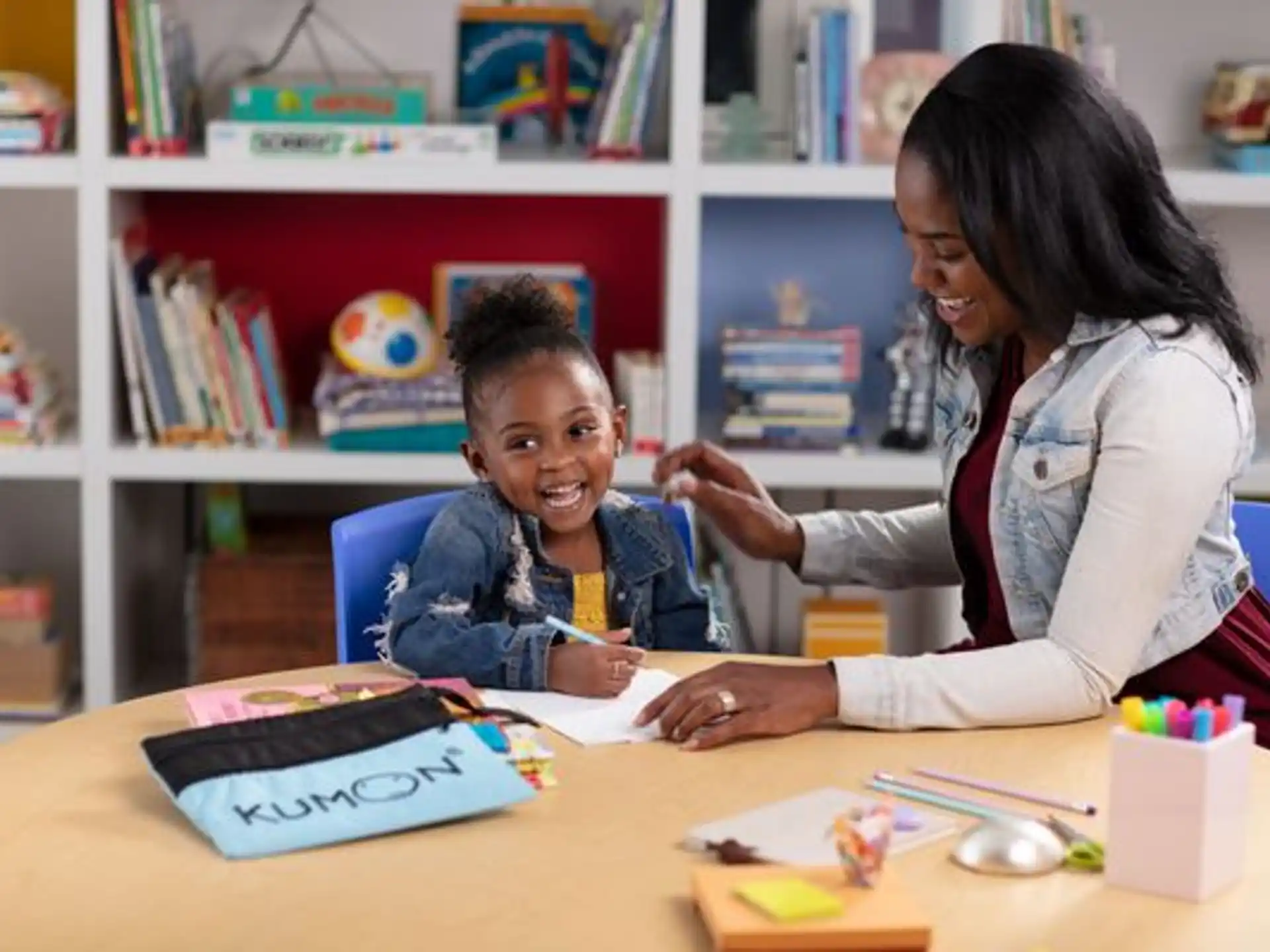 a person and a child sitting at a table
