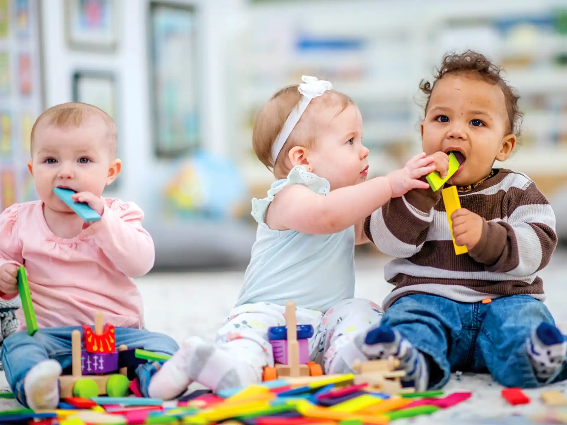 a group of kids sitting on the floor with toys