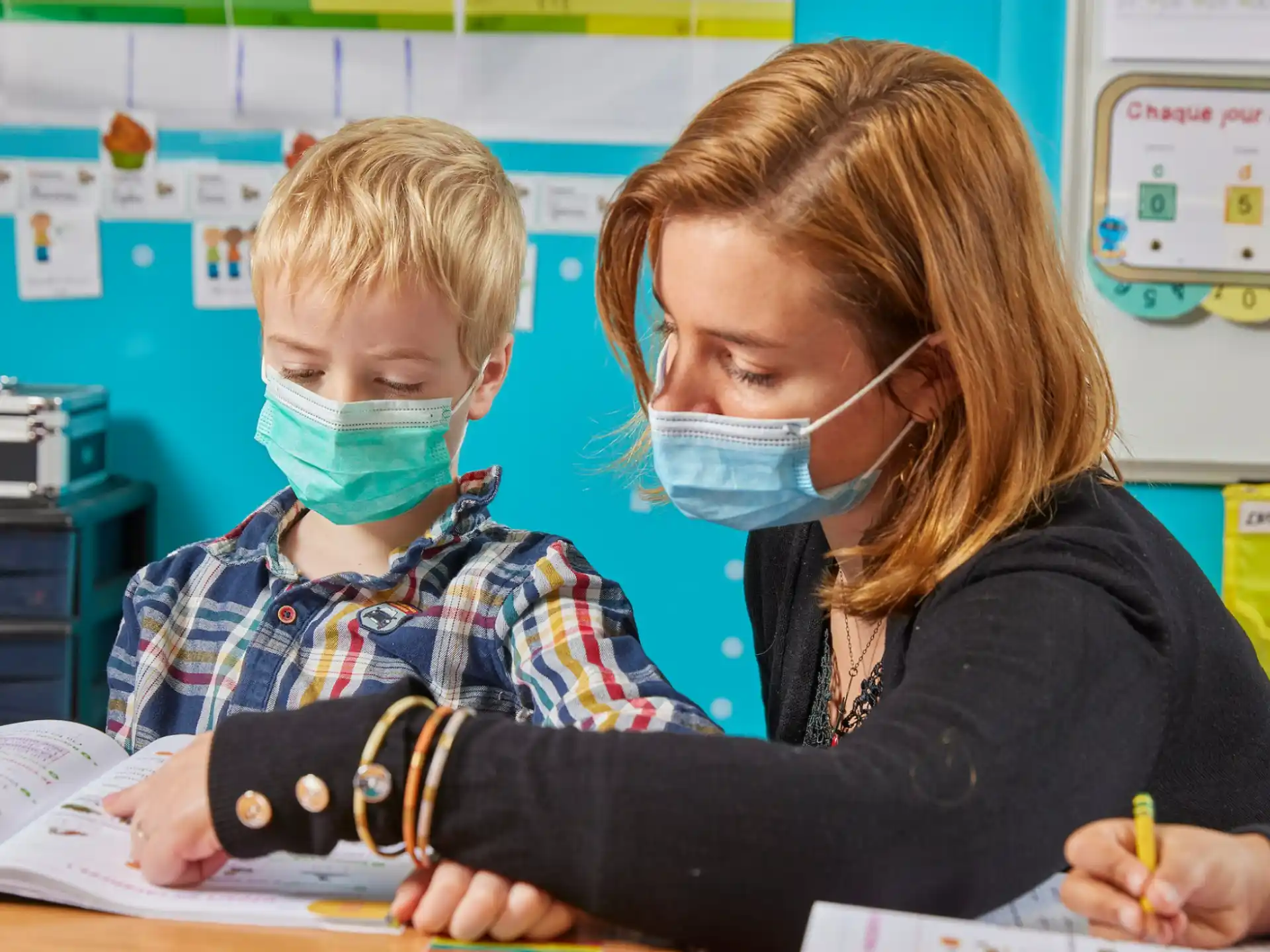 a person and a child wearing face masks