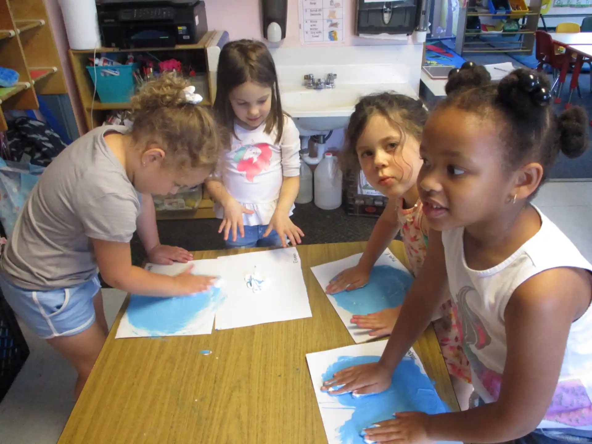 a group of children sitting at a table