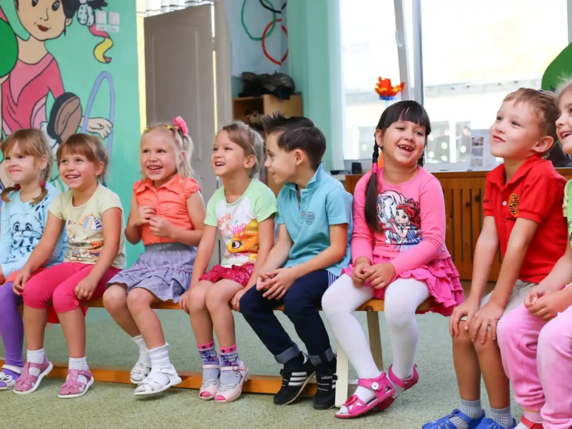 a group of children sitting on a bench
