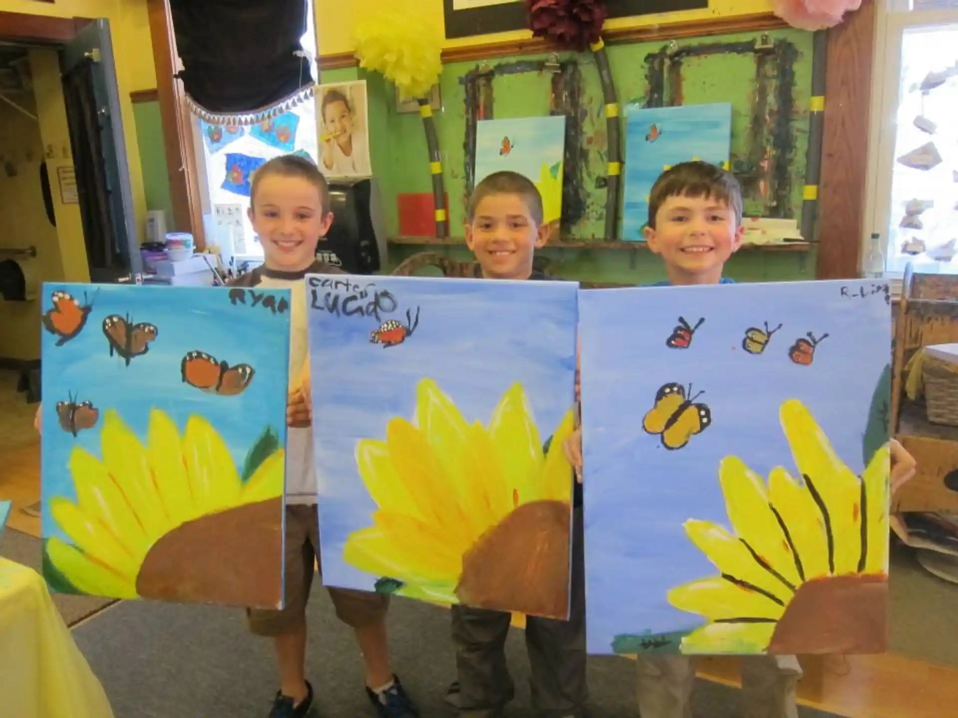 a group of kids holding up colorful paper