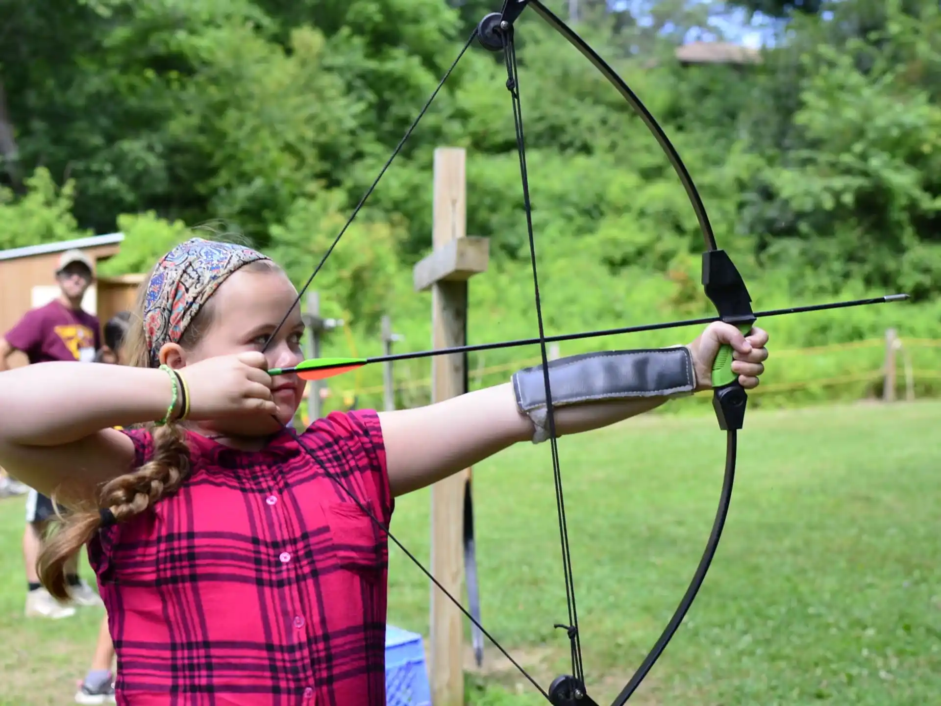 a girl holding a bow and arrow