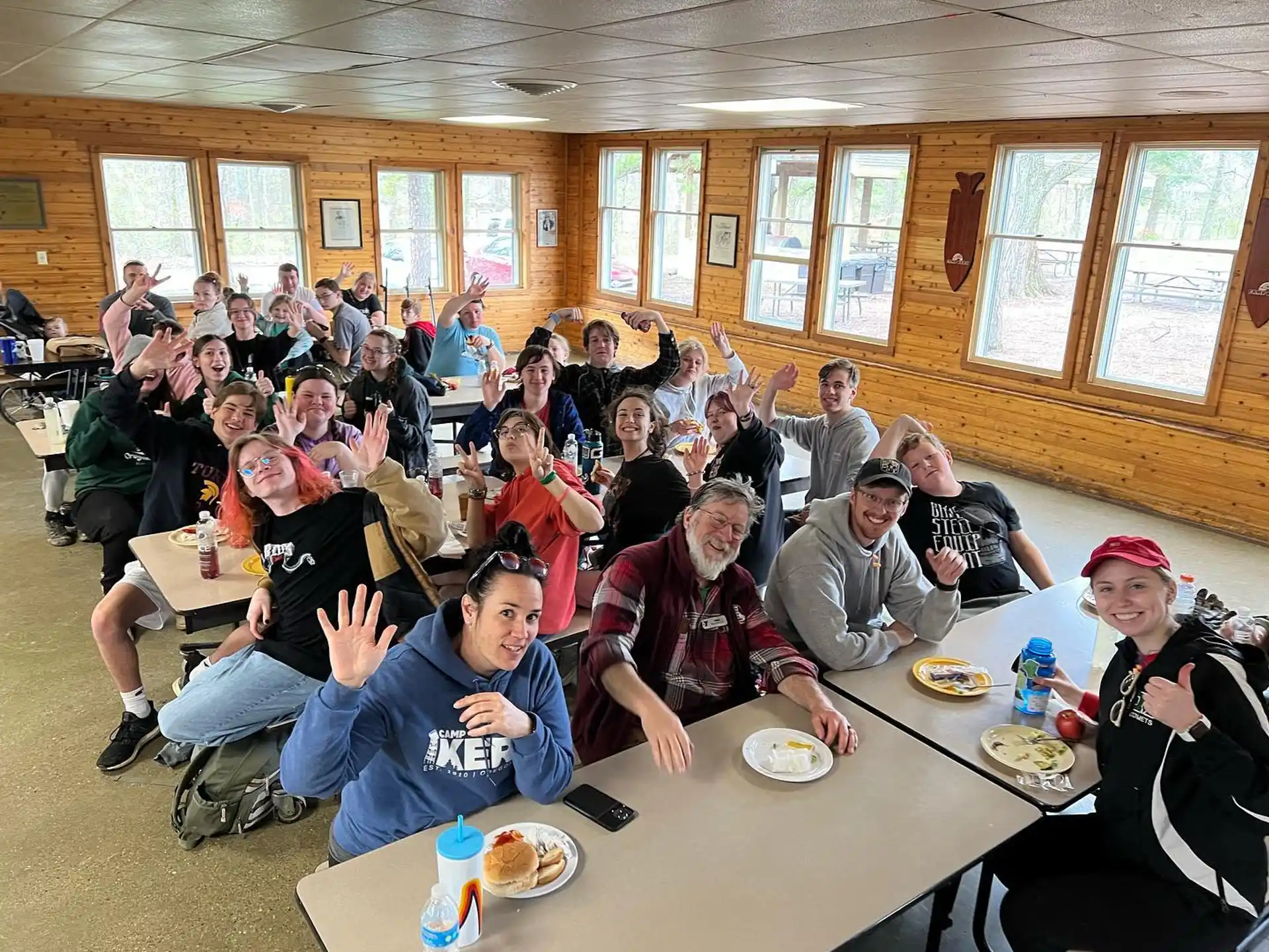 a group of people sitting at tables eating food