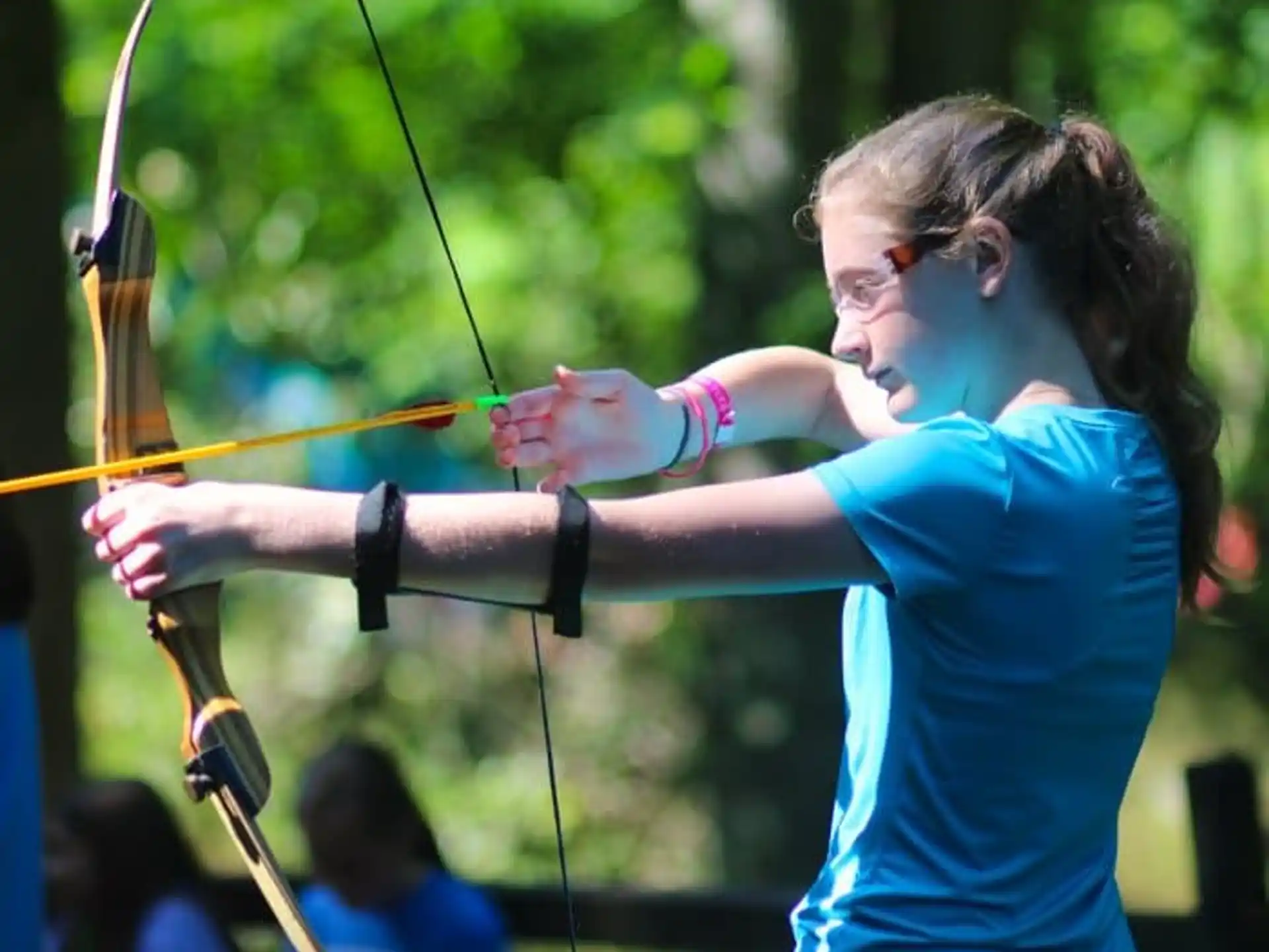 a woman shooting a bow