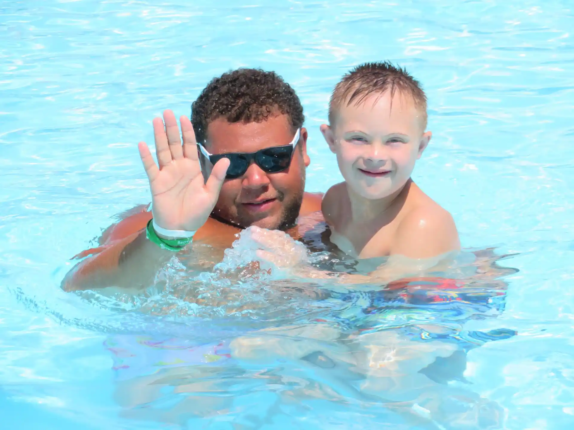 a man and a boy in a pool