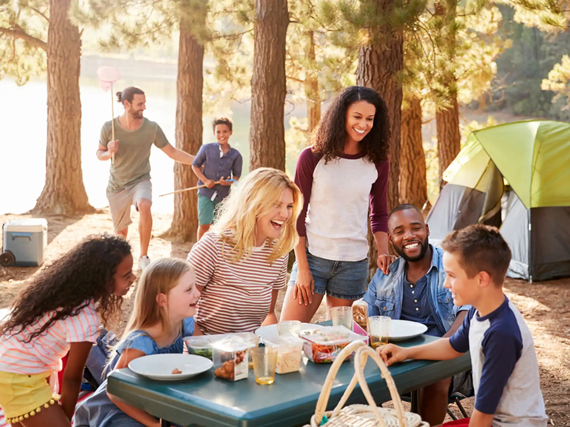 a group of people sitting around a table outside