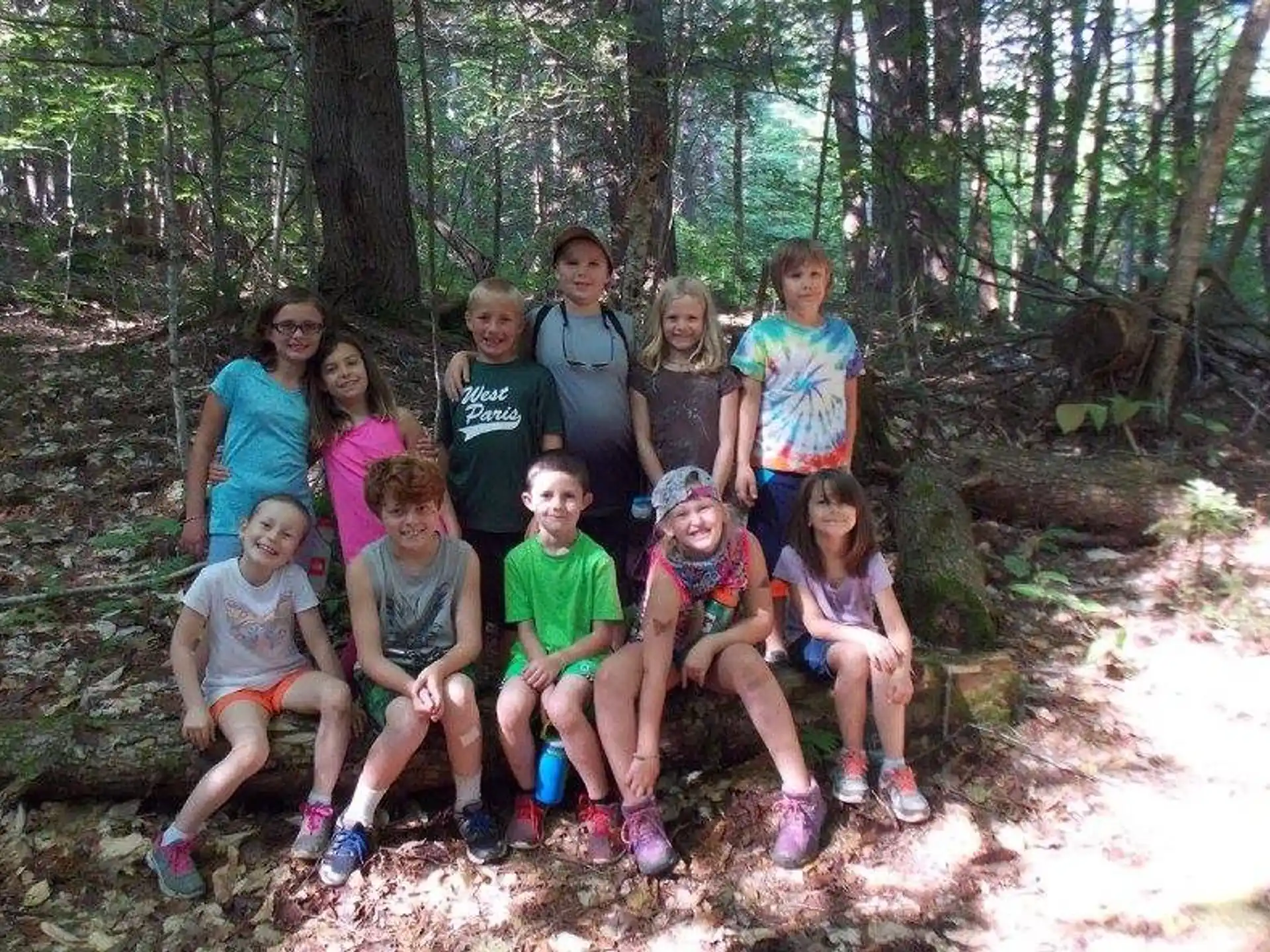 a group of people posing for a photo in the woods