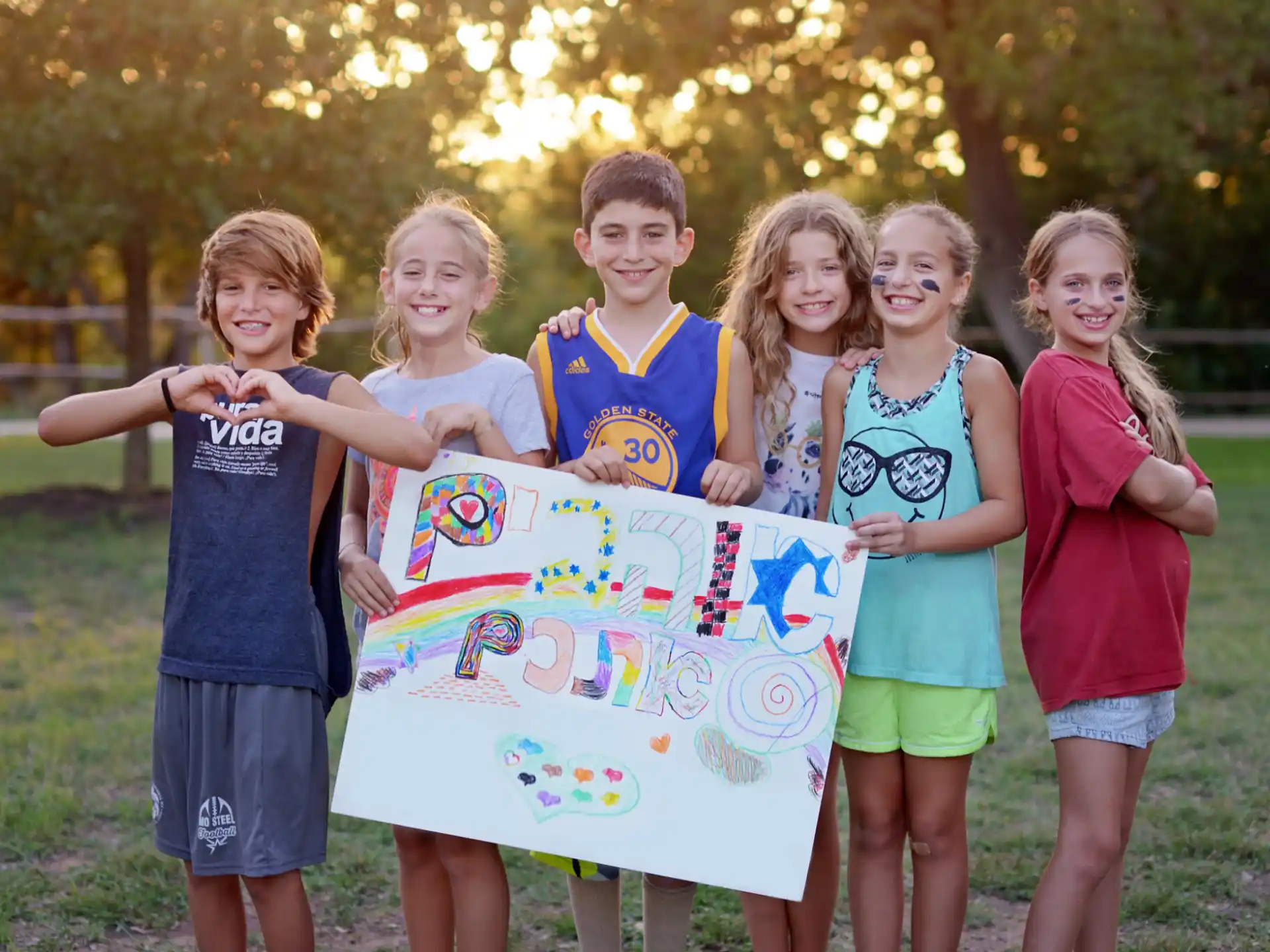 a group of children holding a sign
