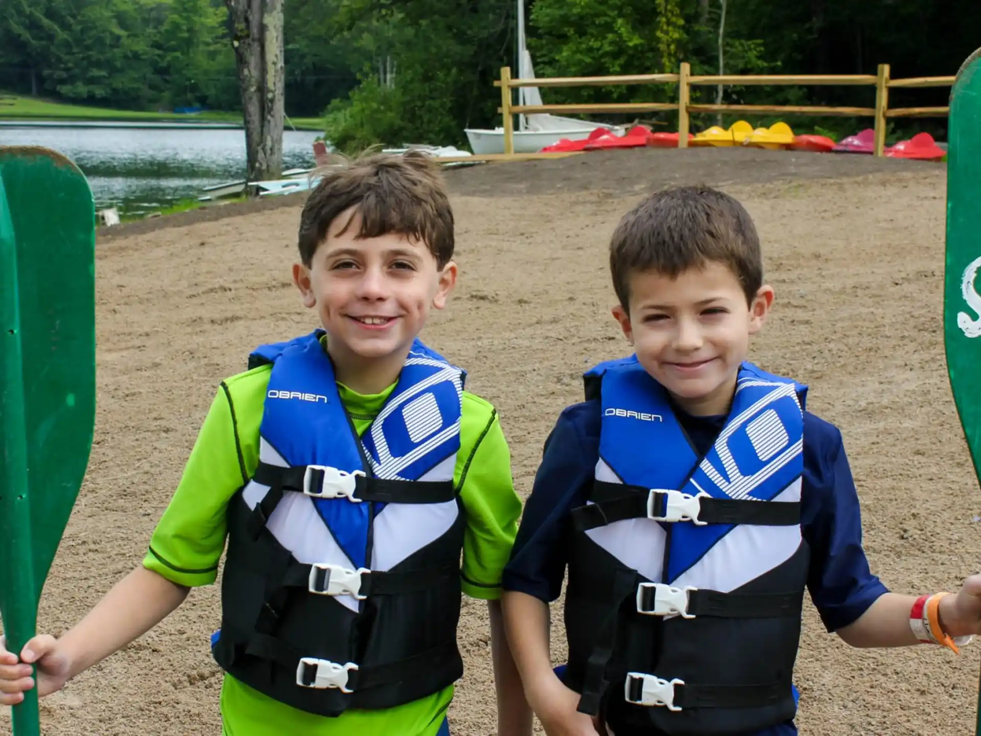 two boys holding paddles