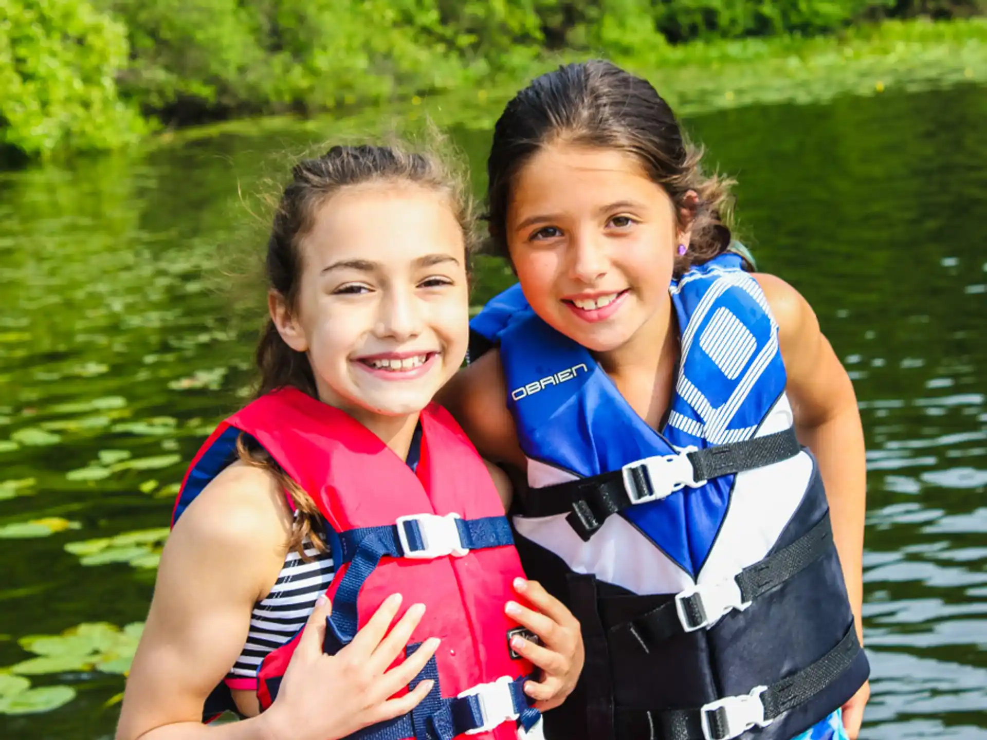 two girls in life jackets