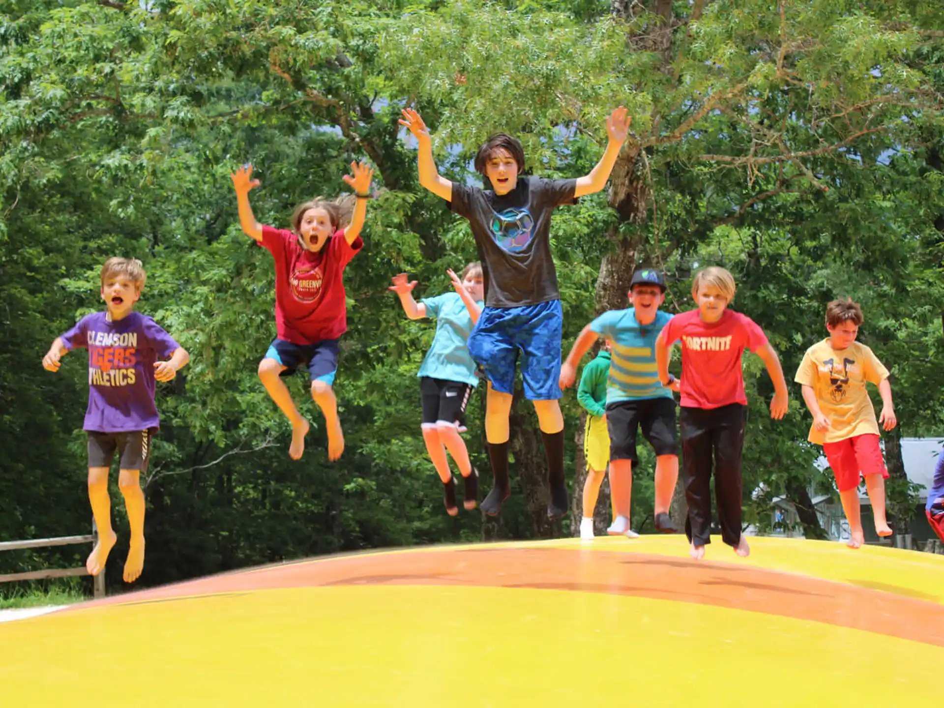 a group of kids jumping on a trampoline