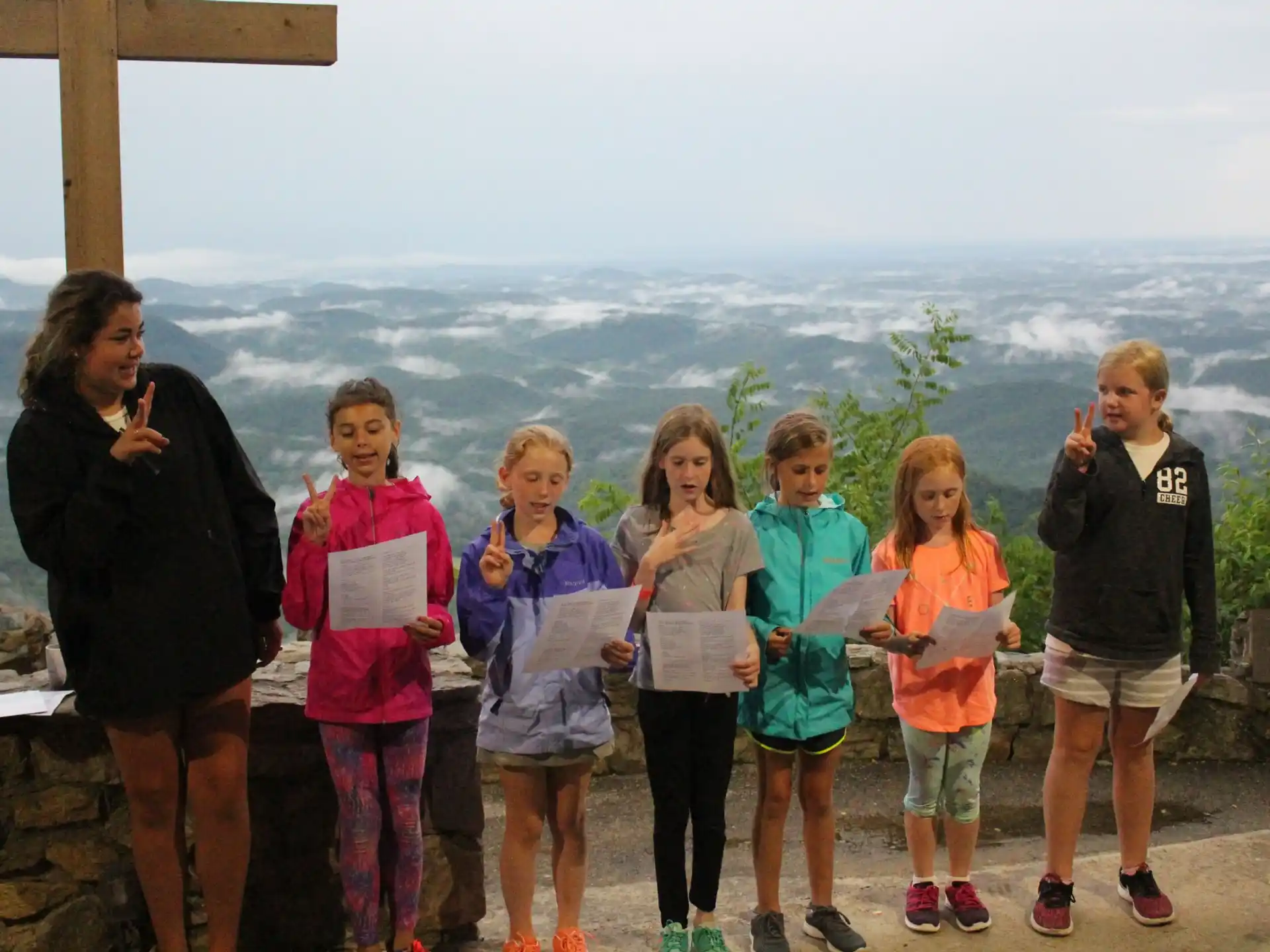 a group of people posing for a photo with a city in the background