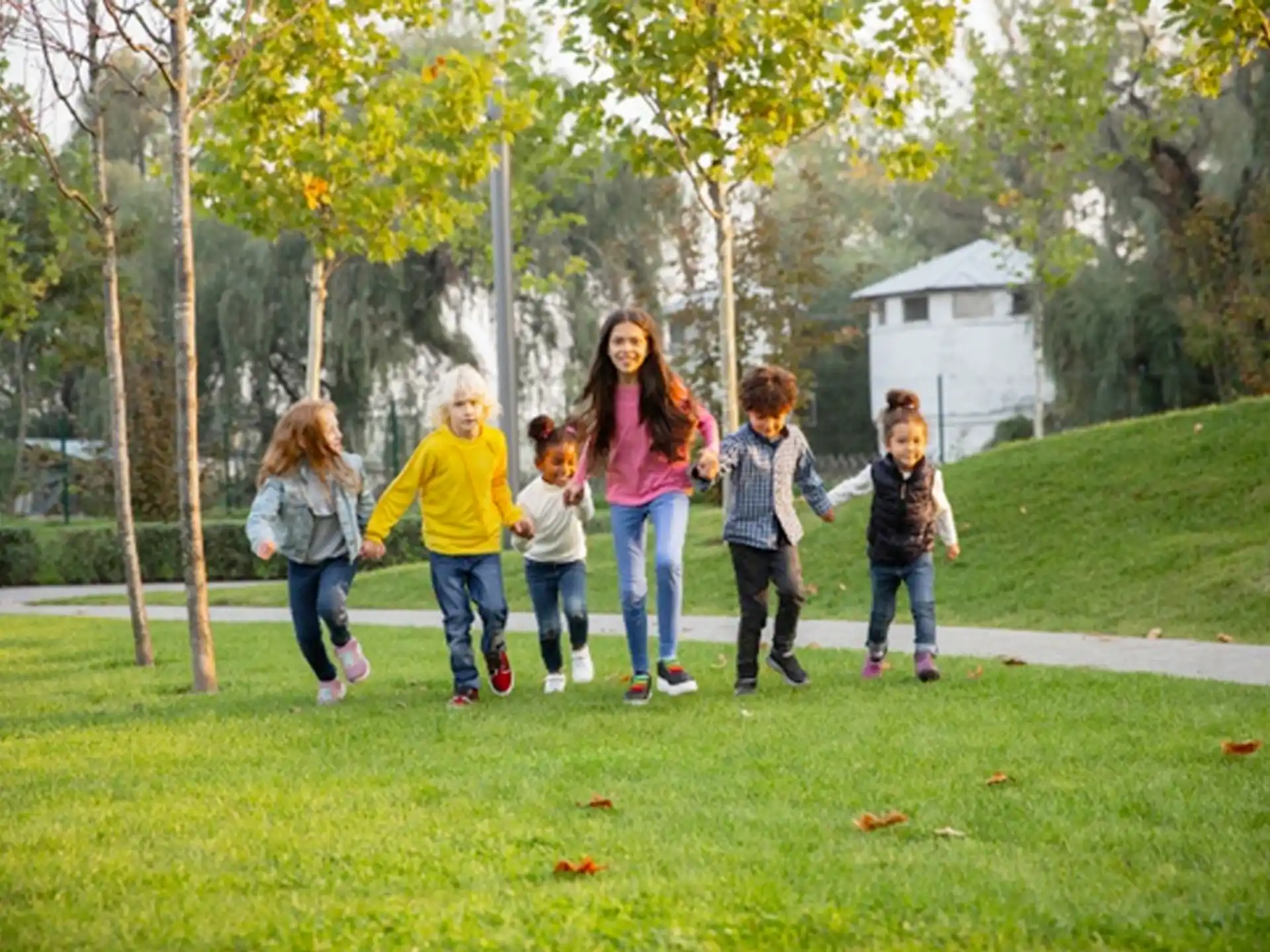 a group of people walking on a grass field