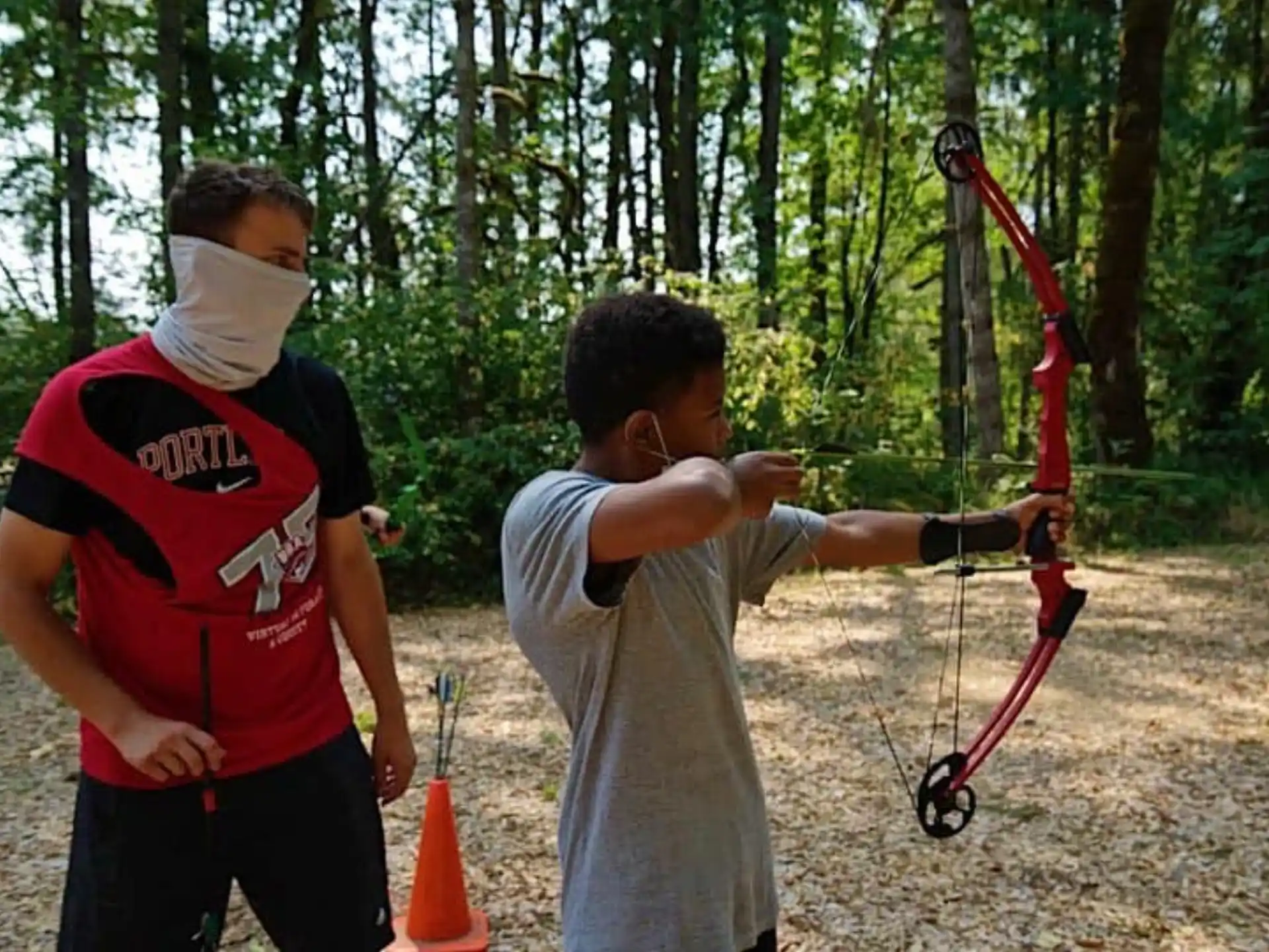 a man shooting a bow and arrow