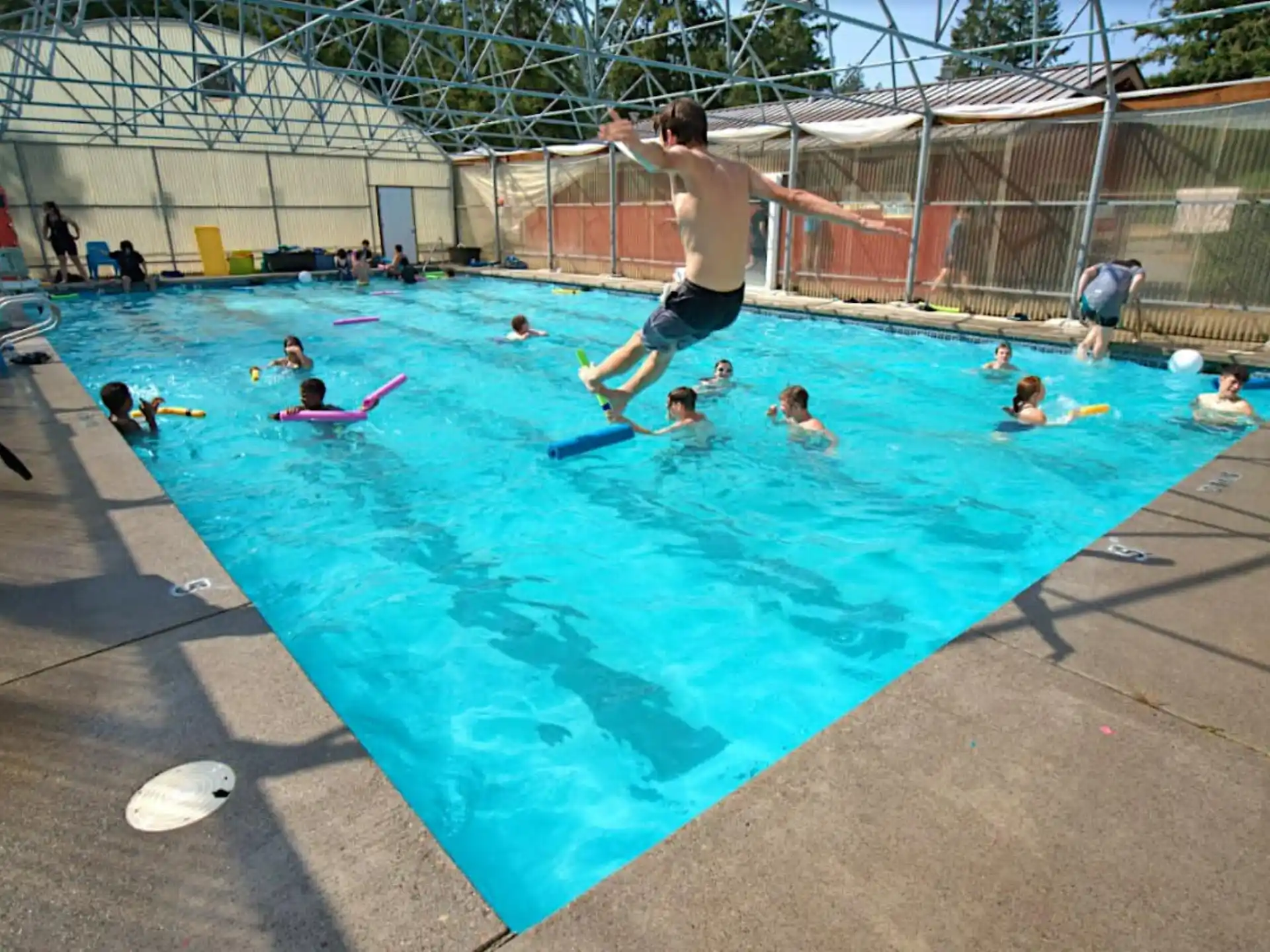 a person jumping into a pool