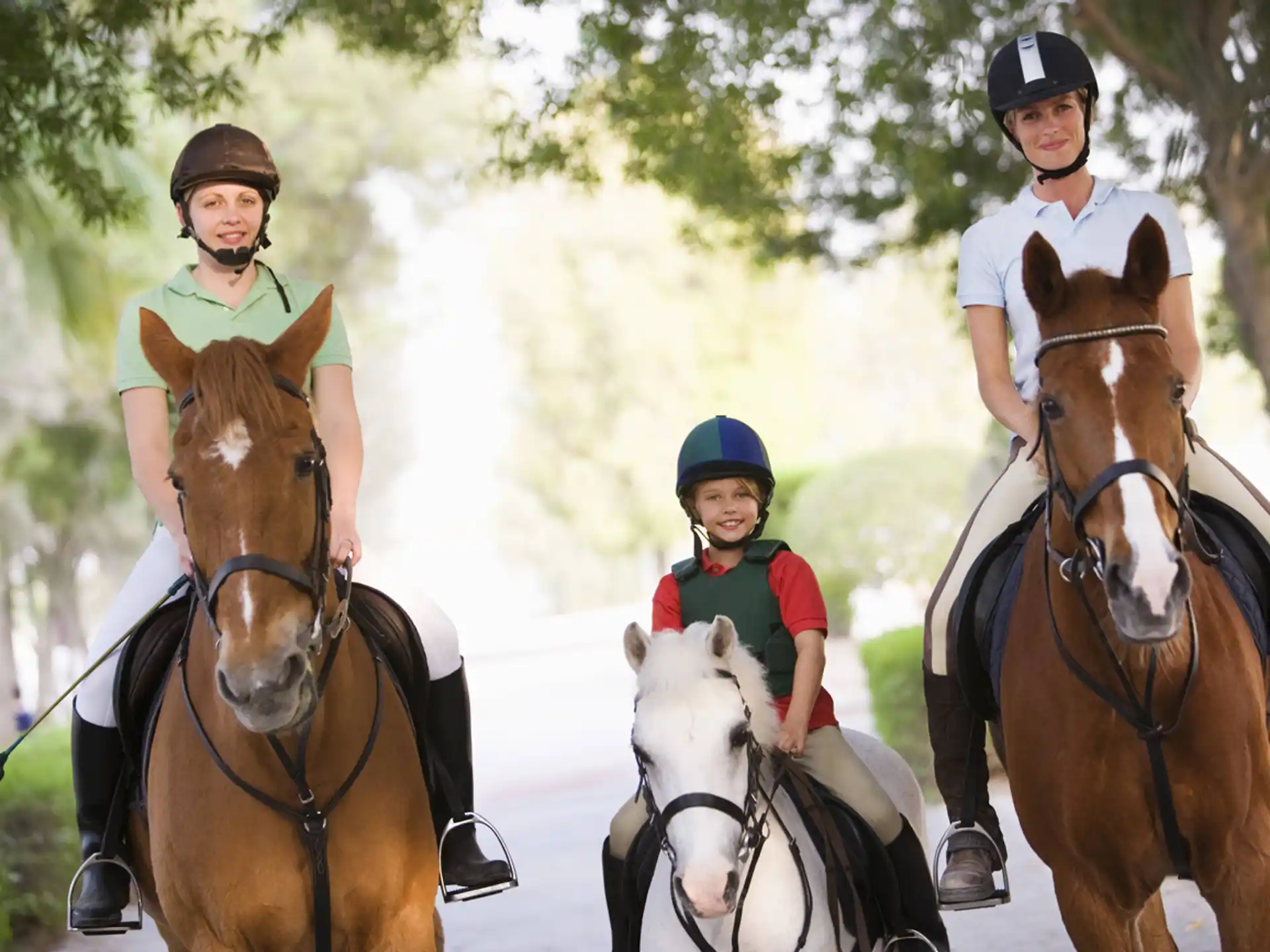 a group of people riding horses