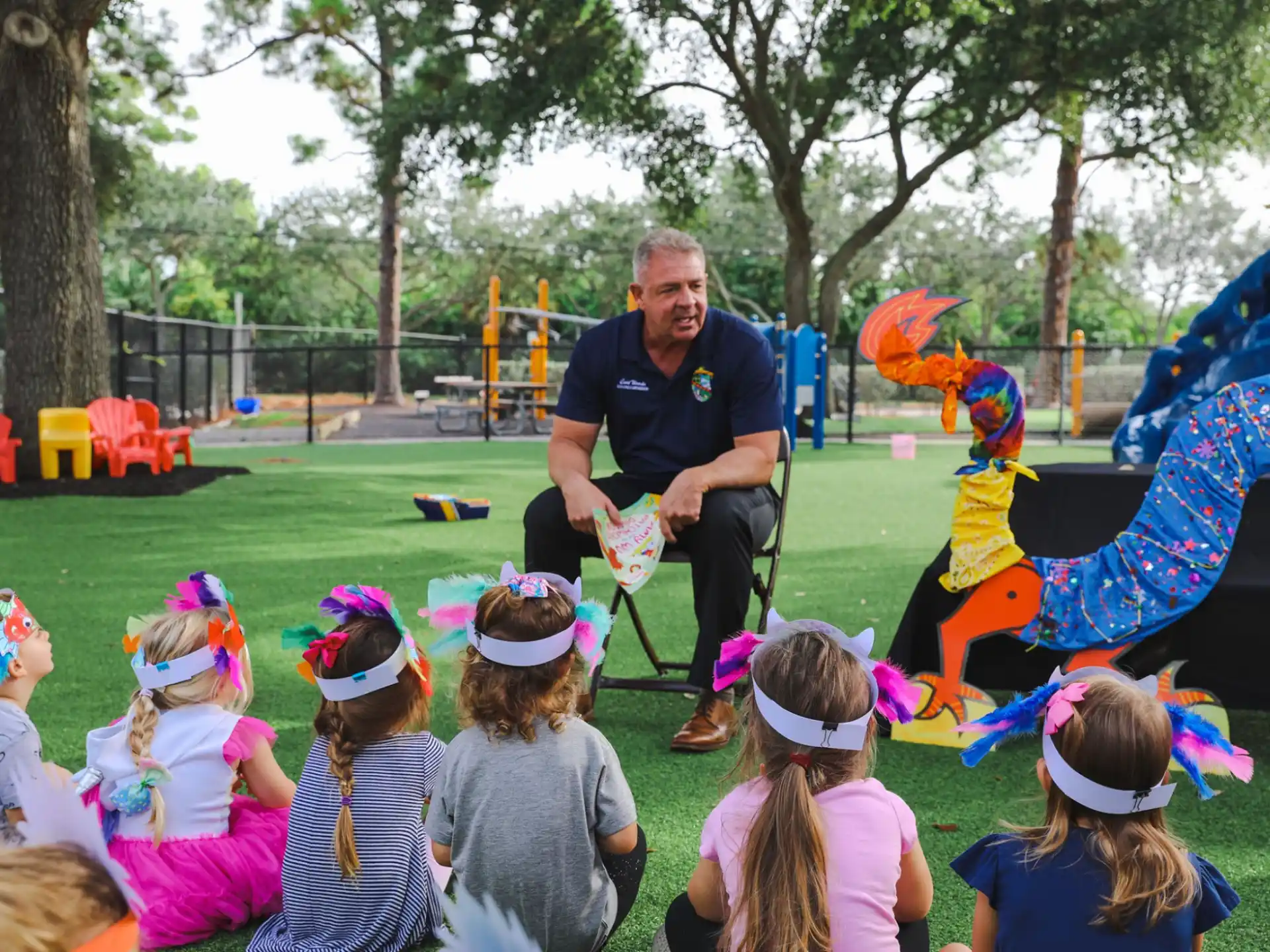 a person sitting in a chair surrounded by children