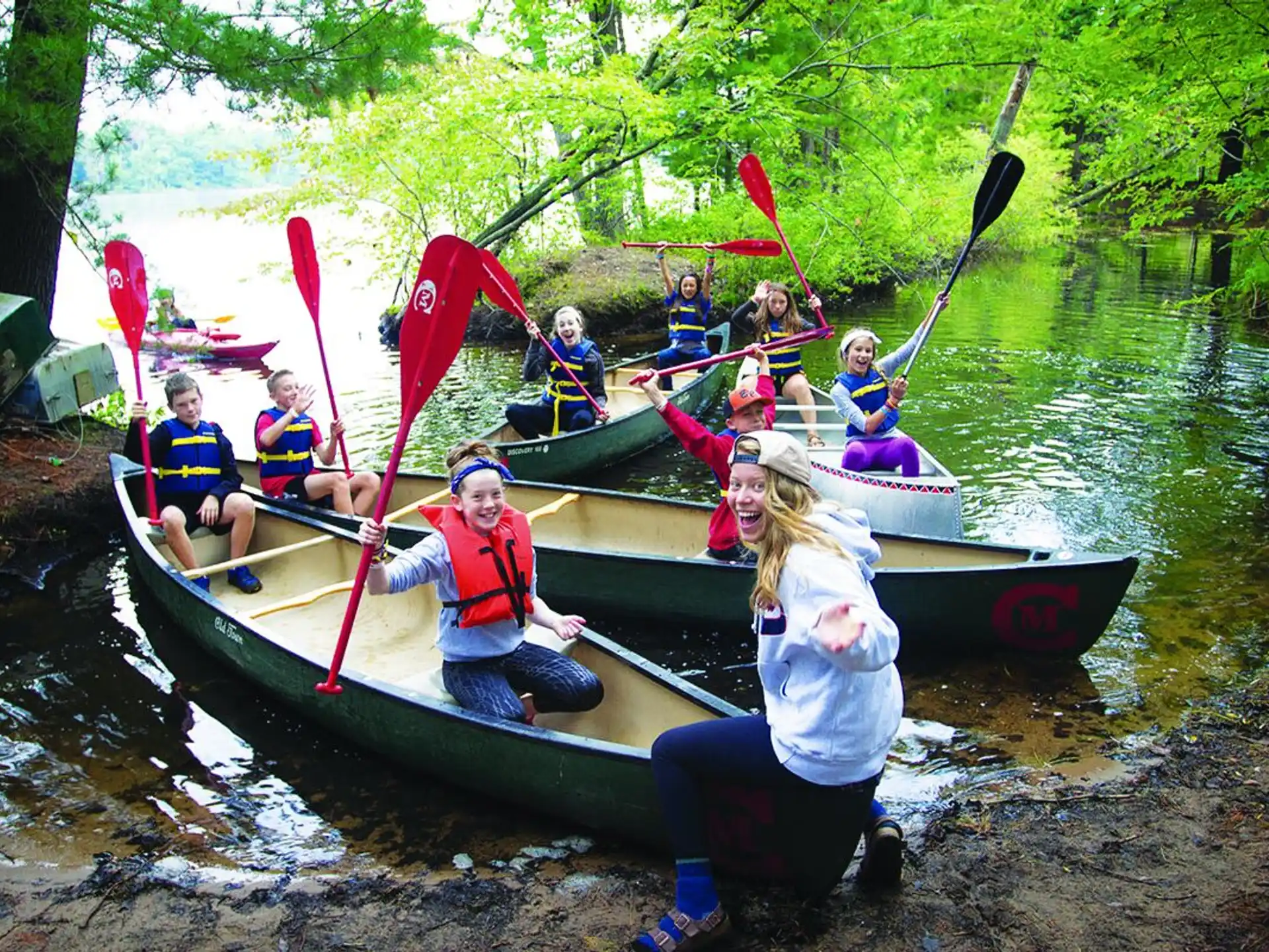a group of people in canoes
