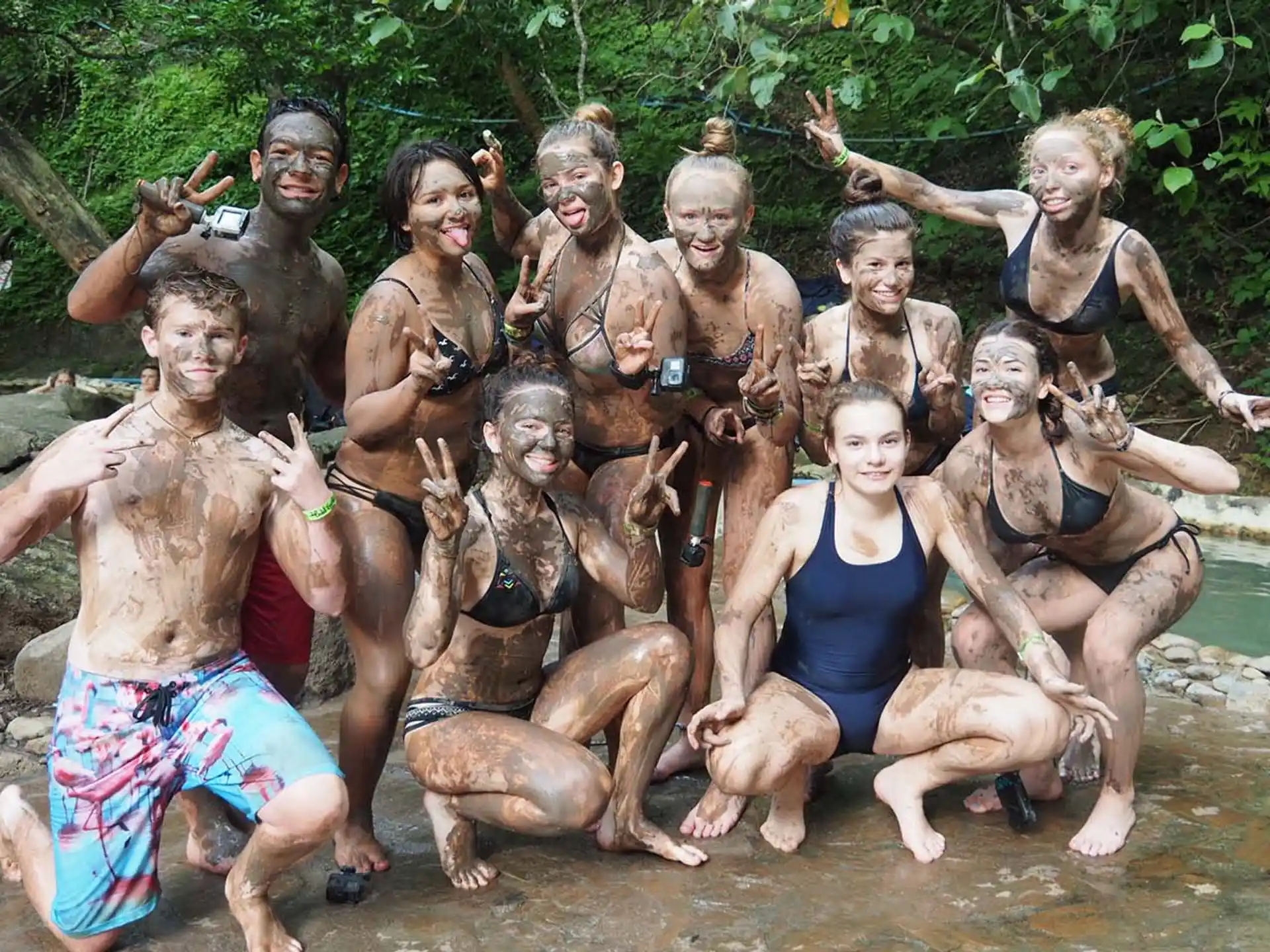 a group of people posing for a photo in a river