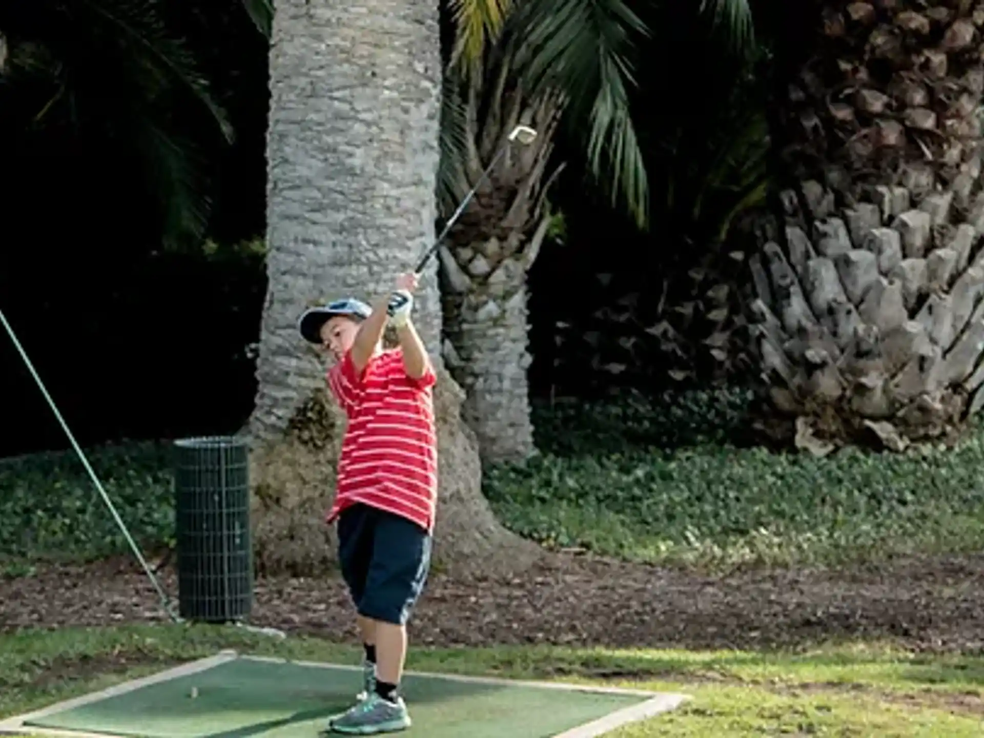 a person swinging a golf club
