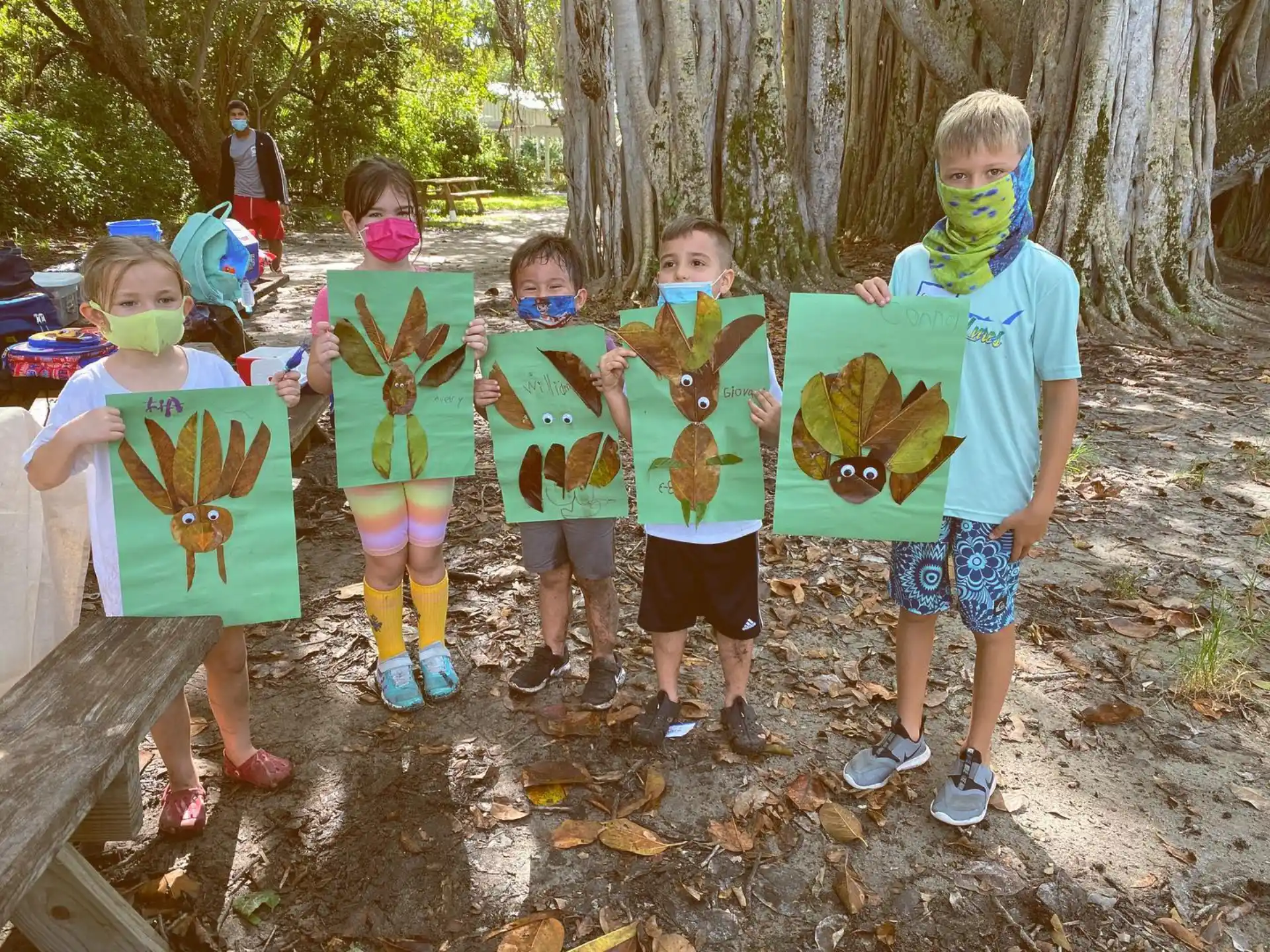 a group of children holding up paper bags