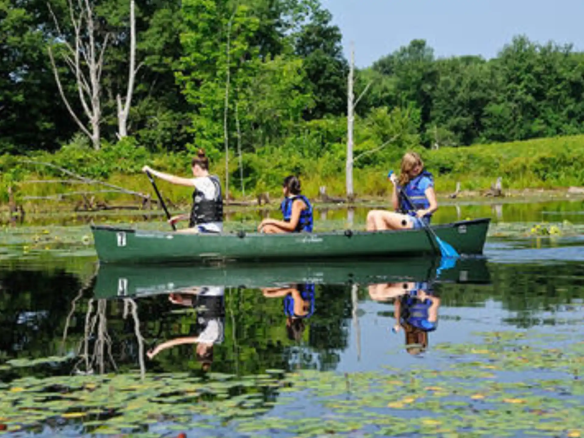 a group of people in a canoe on a lake