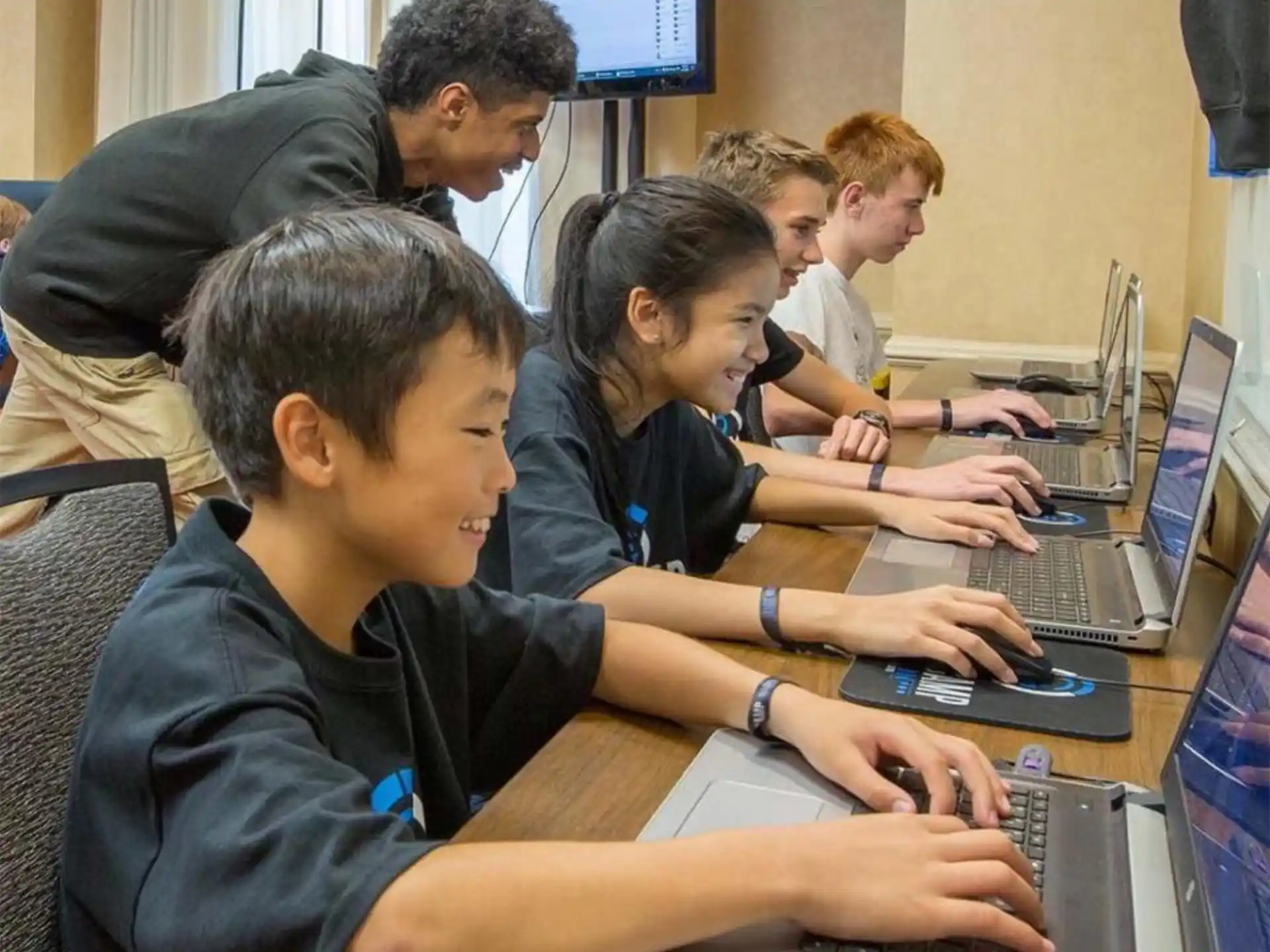 a group of people using laptops