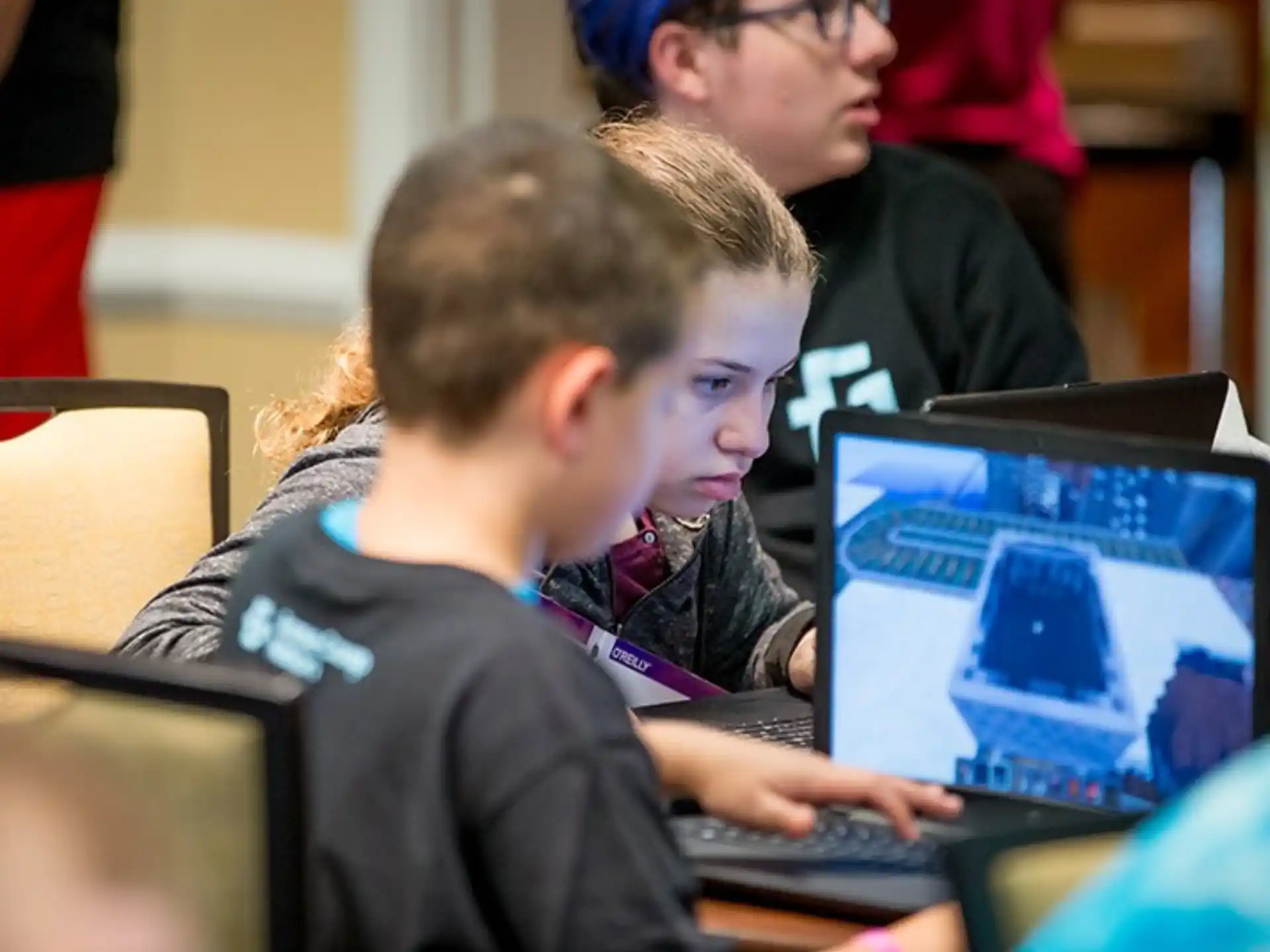 a group of people using laptops