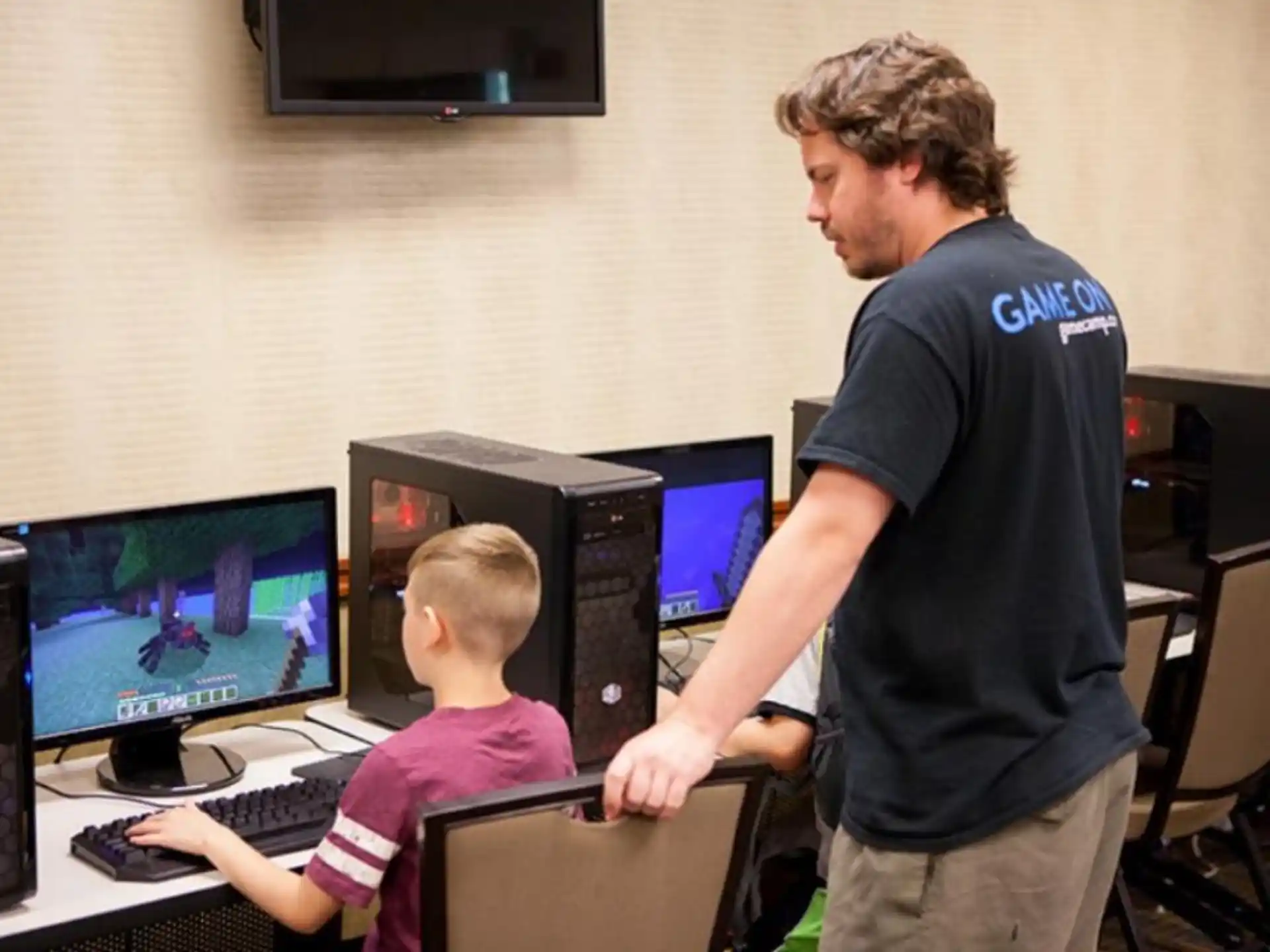 a man and a boy using computers
