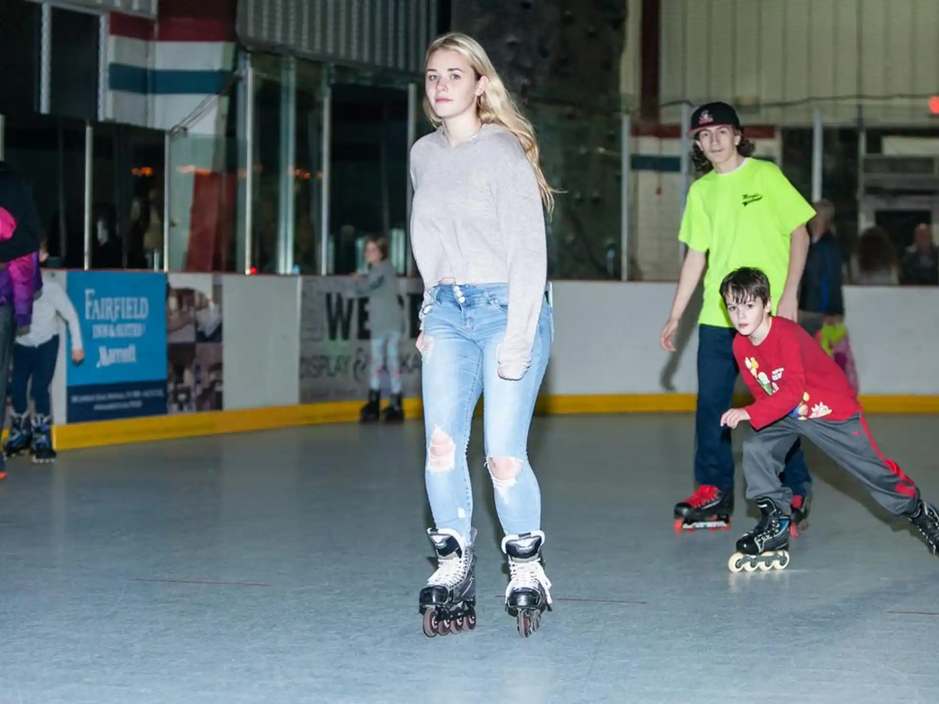 a person and a couple kids on roller skates