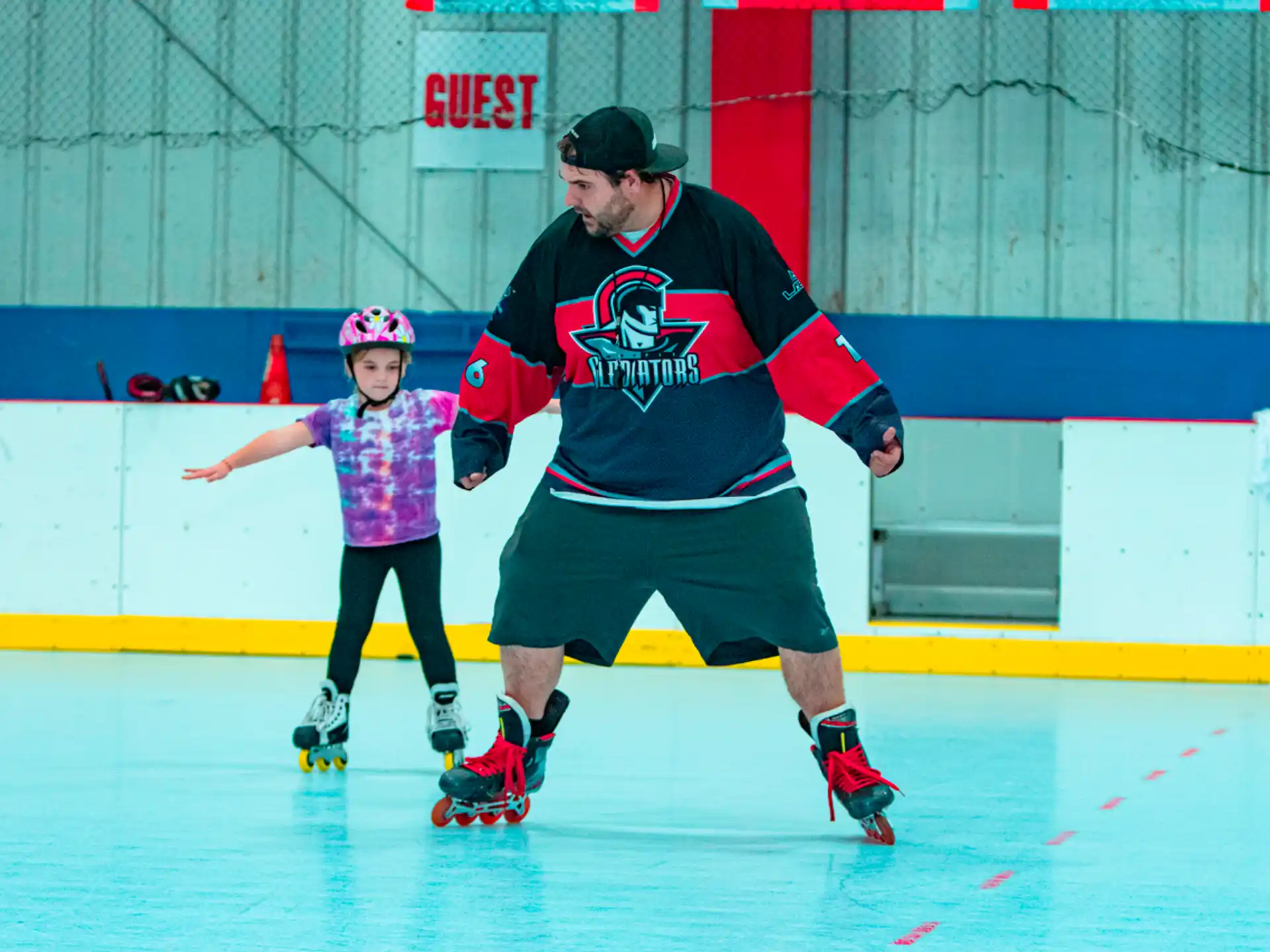 a person and a girl wearing roller skates and helmets