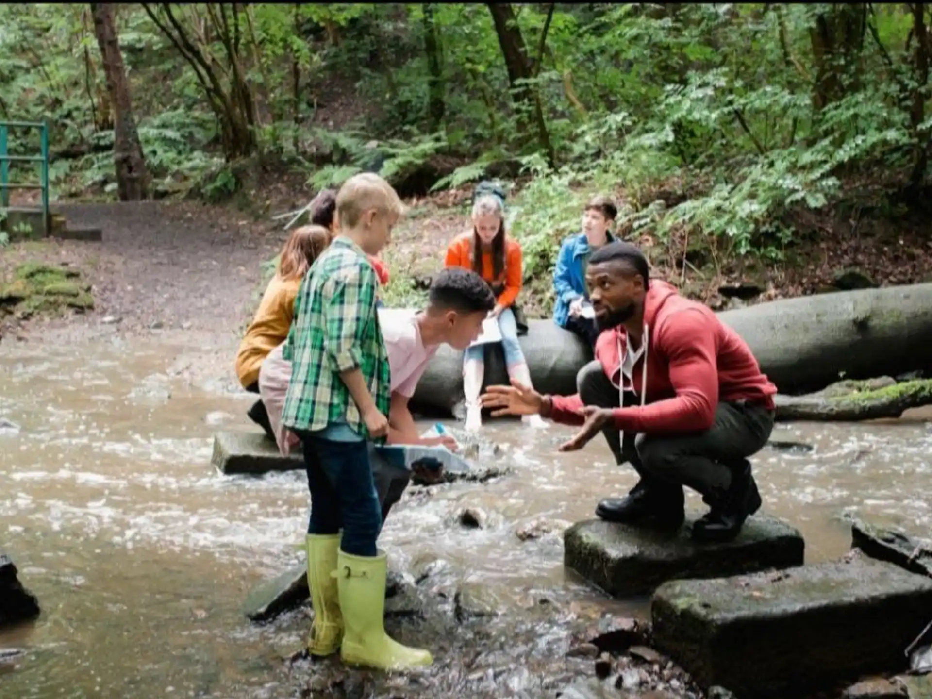 a group of people standing in a river