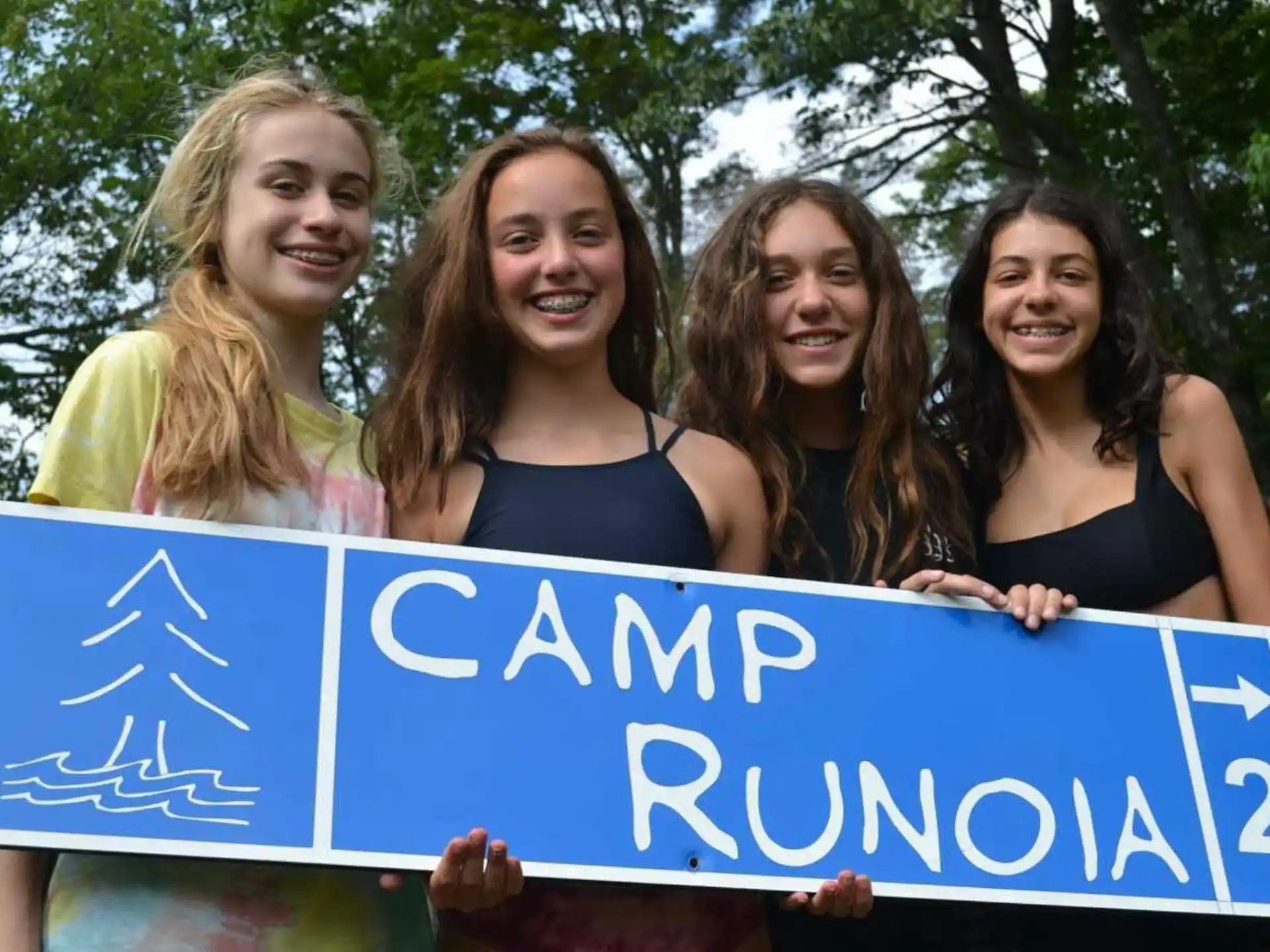 a group of women holding a sign