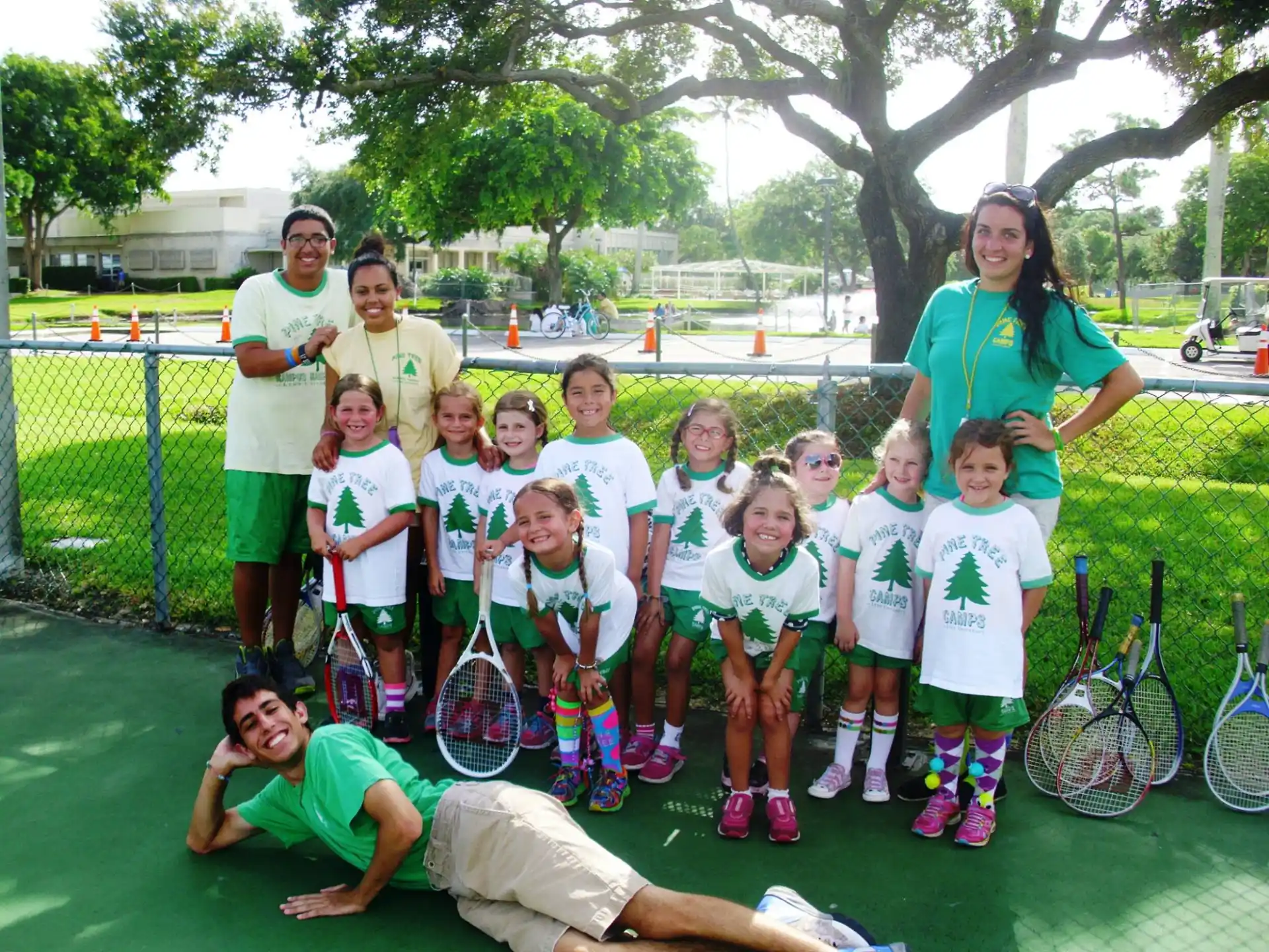a group of people holding tennis rackets