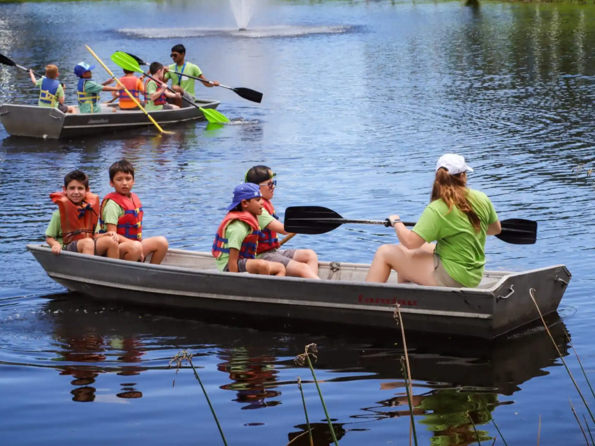 a group of people in a row boat on water