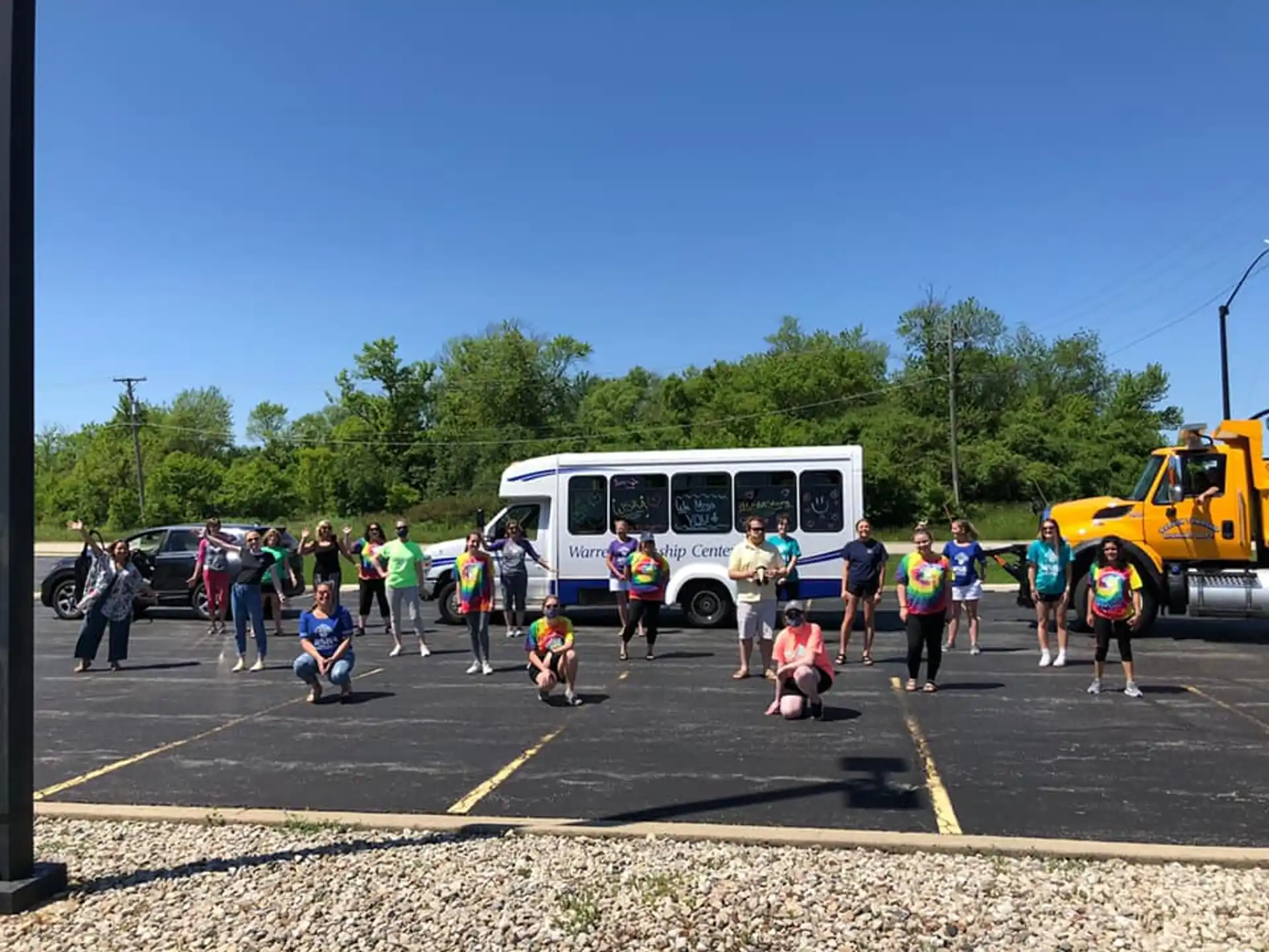 a group of people walking in a parking lot