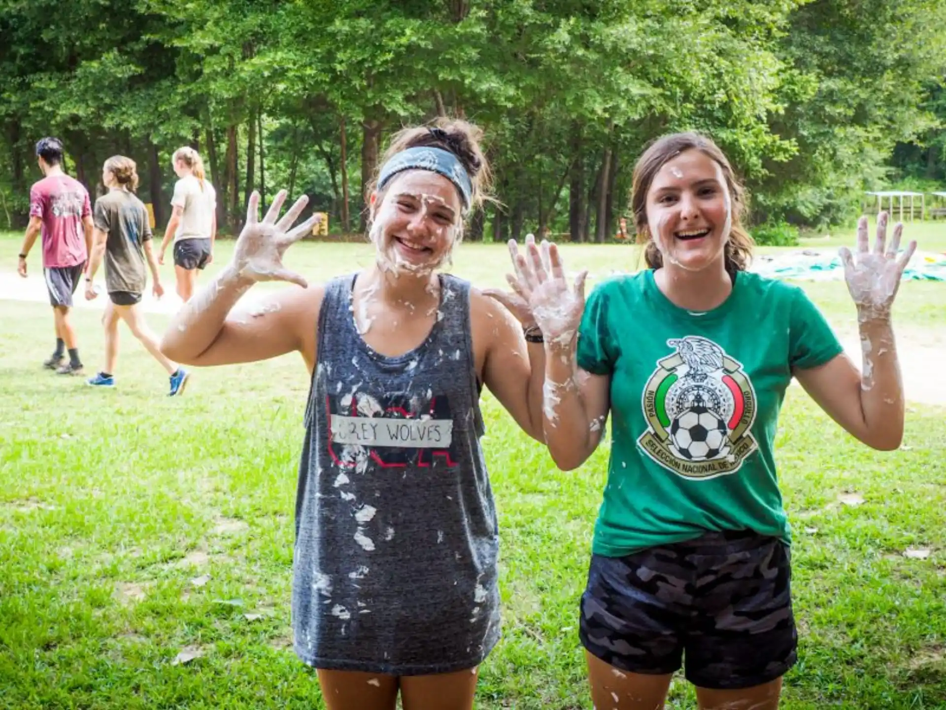 a couple of women posing for a picture with their arms raised