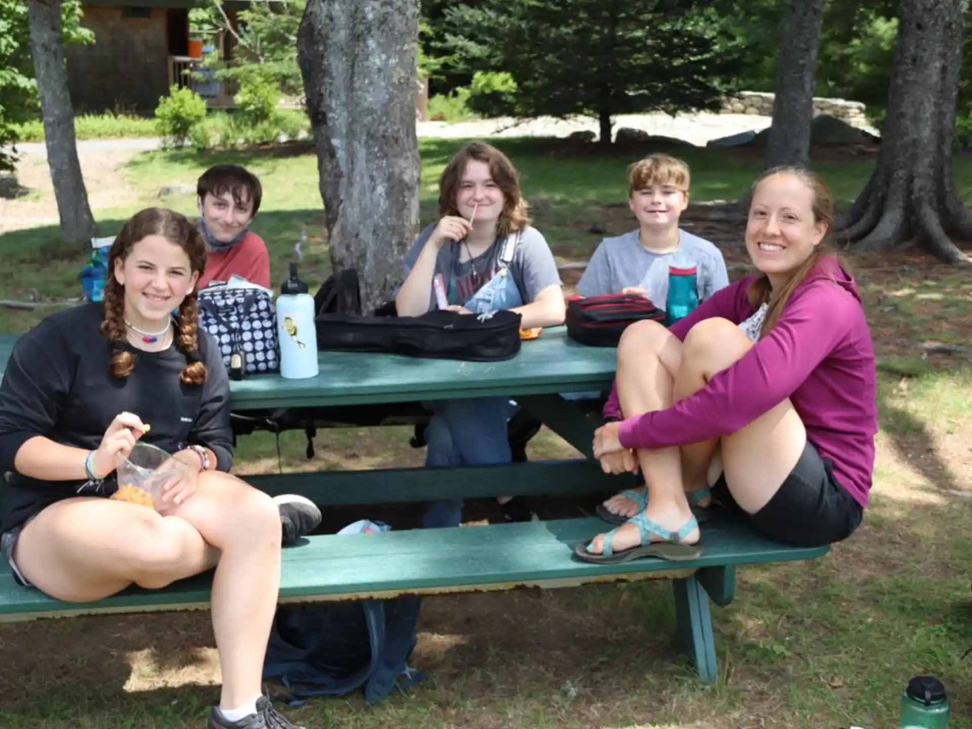 a group of people sitting at a picnic table
